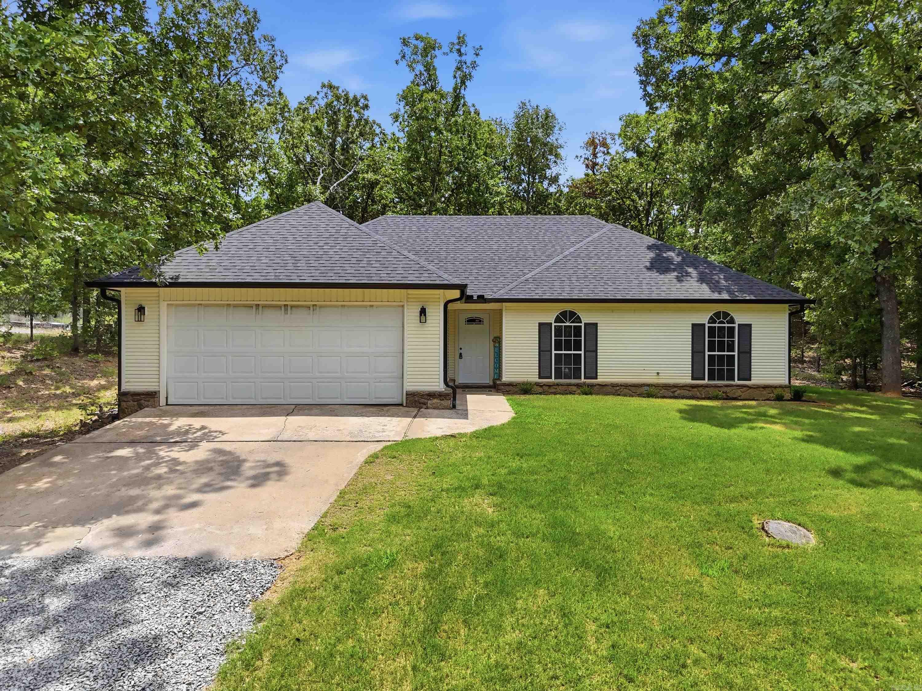 Completely remodeled and move-in ready, this beautiful 3-bedroom, 2-bath home offers 1,335 square feet of stylish living on 2 private acres. Inside, you'll love the spacious great room with soaring vaulted ceilings and a cozy wood-burning fireplace, creating the perfect gathering space. The large kitchen features new countertops, a stylish backsplash, breakfast bar, and adjoining dining area, making it ideal for everyday living and entertaining. A separate laundry room and beautifully updated bathrooms with new vanities add convenience and modern appeal. Extensive 2026 renovations include a new roof, new gutters, luxury vinyl plank flooring, fresh paint throughout, updated lighting, and new landscaping. A water softener is an added bonus. Enjoy the peace and privacy of country living with plenty of room to spread out while still having nearby neighbors. Located on a quiet dead-end road with no HOA, this property offers the best of both worlds—seclusion and convenience—just a short drive to Conway and Greenbrier. Simply move in and start enjoying everything this turnkey home has to offer!