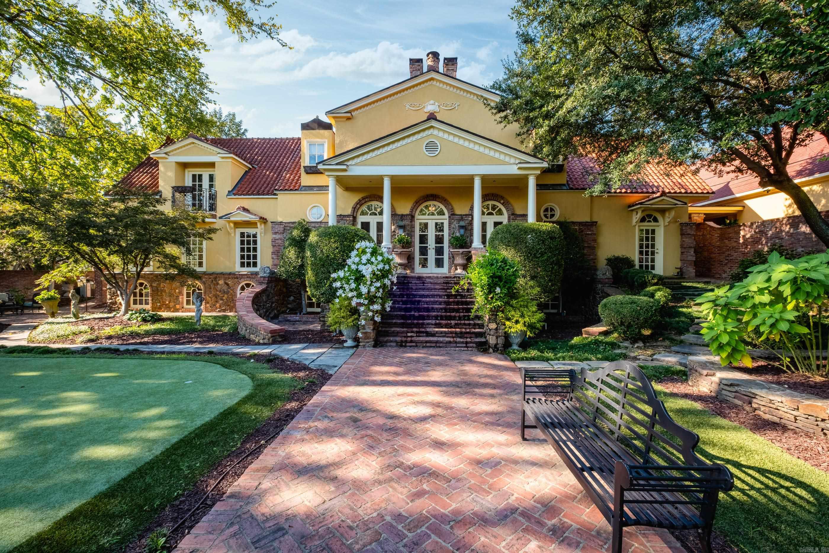 Discover a very rare opportunity for a secluded private estate in Hillcrest, sprawling across 3 parcels with 4 distinct buildings. The main residence is an exquisite 4775sqft, 3BR, 3.5BA home featuring rich walnut floors, custom cabinetry, and wood-burning fireplace. Serene poolside views blend indoor & outdoor living spaces. Primary suite includes a jetted tub, walk-in shower, large walk-in closets, a separate laundry room, gym, and office/theater space, and a balcony overlooking the gardens and pool. Lower level has 2 bedrooms, spacious shared bath, and 2nd laundry. The outdoor oasis boasts a stunning pool, meticulously designed terraced gardens with antique brick, 5-hole putting green, several outdoor entertaining areas including a fireplace with a soaring curved stone chimney. Guest house w/approx 2500SF, 2-3BR, 3BA, 2nd living area; Pool house: Charming 1BR/1BA with wood stove, offering a cabin retreat vibe; Greenhouse connected to the pool house is climate-controlled space w/vaulted ceilings & skylights, perfect for garden supplies, winter plants, or an artist's studio. Oversized 4-car garage with 2nd floor storage. Inquire for additional photos of pool house and guest house.