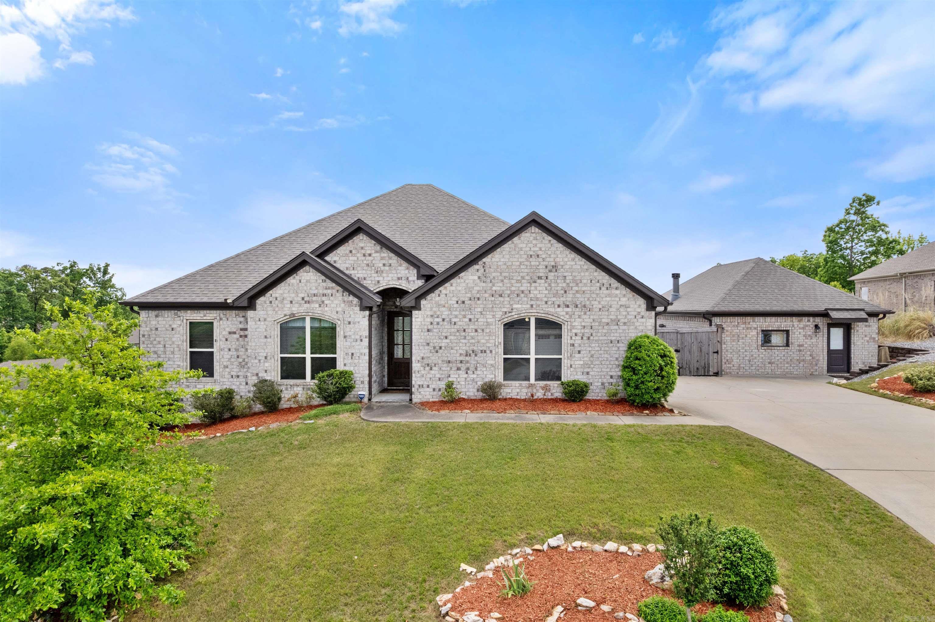 Discover the peace and privacy of Lochridge Estates, a gated subdivision with Lake Florence just two blocks away. This well-kept home offers stunning 10-mile views and unforgettable sunsets from a 525 sq ft two-level deck. Owned for the past 8.5 years by a senior bachelor, this is truly a “low mileage” home. The 2,050 sq ft main house features 3 bedrooms, 2 full baths, a jetted tub, walk-in closet, tray ceilings in two bedrooms, and a vaulted ceiling in the third. The open kitchen and den create a spacious, welcoming feel. New roof and gutters were installed in 2024, plus new garage tile flooring in 2025. The 850 sq ft guest house, completed in 2019, is perfect for guests, a home office, in-law quarters, or a man cave. It includes a 4th bedroom, bathroom, pantry, bar, and wood-burning fireplace. A whole-house Generac generator powers both homes. Situated on a half-acre corner lot with one of the best views in Lochridge, you’ll enjoy a quiet country feel while being just 7-8 minutes from The Promenade, Costco, and Kroger. The home was professionally inspected on 4/22/26, with only a few minor items being addressed. Energy-efficient living keeps total annual utilities under $3,000!