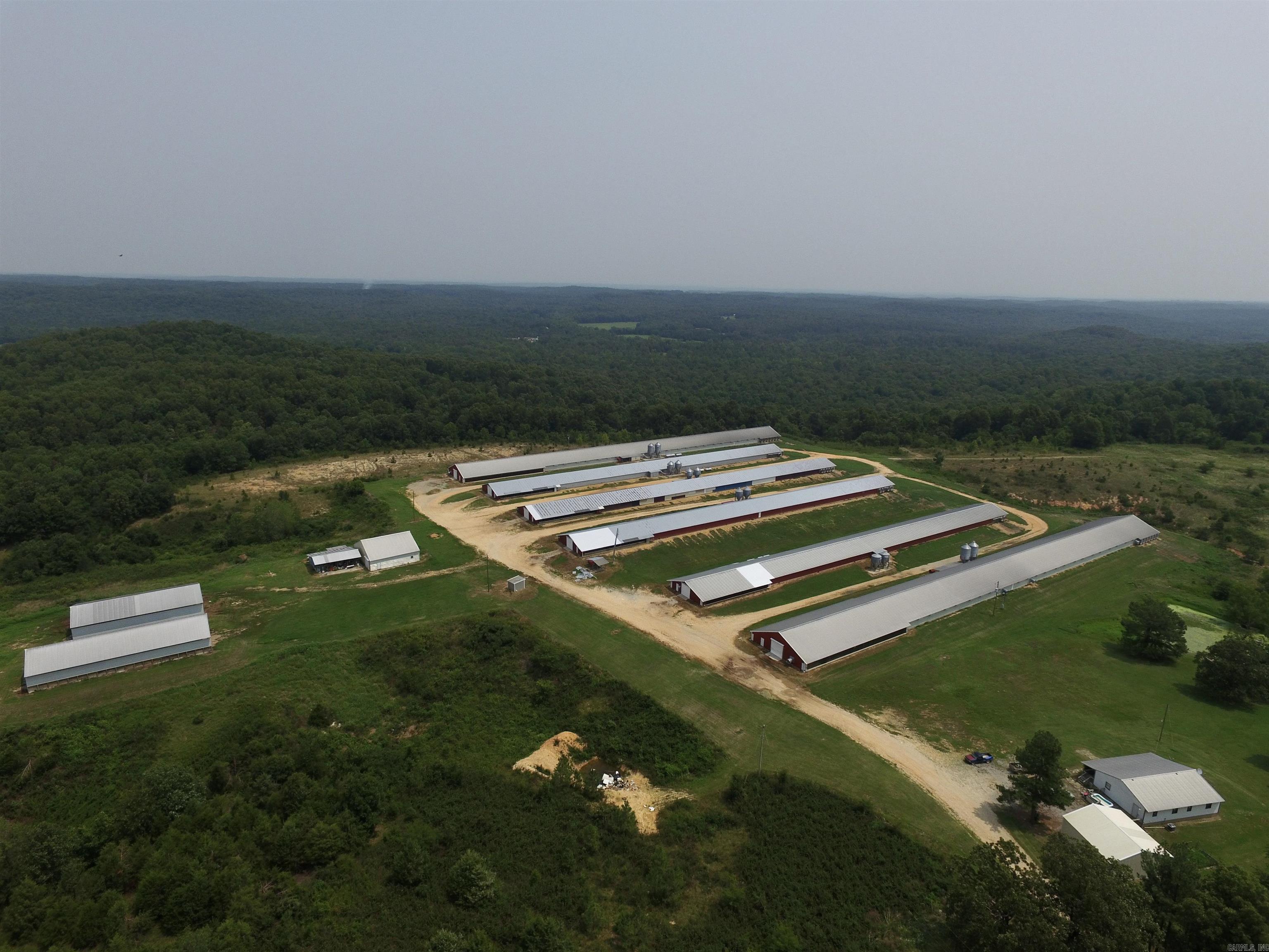 Fully operational Poultry Farm w/Active Contracts on Approx 125 Acres and Meets Compliances for George's and Ozark Mountain Poultry Standards.  Six (6) Active Updated Poultry Grow Houses, Two (2) Litter Barns, One (1) Water Storage Room Foam Insulated and Heated, and Onsite Manager Dwelling / Home.  Well Water and City Water Onsite.  Turn Key Operation ready to new owner.  See Agent Remarks.