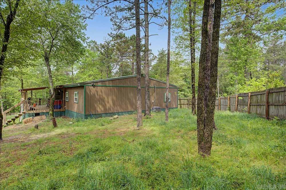 Need some elbow room?  Take a look at this five bedroom/2 bath home on ten+ acres just West of Amity, Arkansas.  It was constructed 1n 2020 and features an open floorplan, combining the living room, kitchen and the dining area.  Most of the property is covered in timber.  One half acre has a privacy fence.  High speed internet is available.  The home is occupied so provide advance notice to the listing agent to schedule a showing if possible.