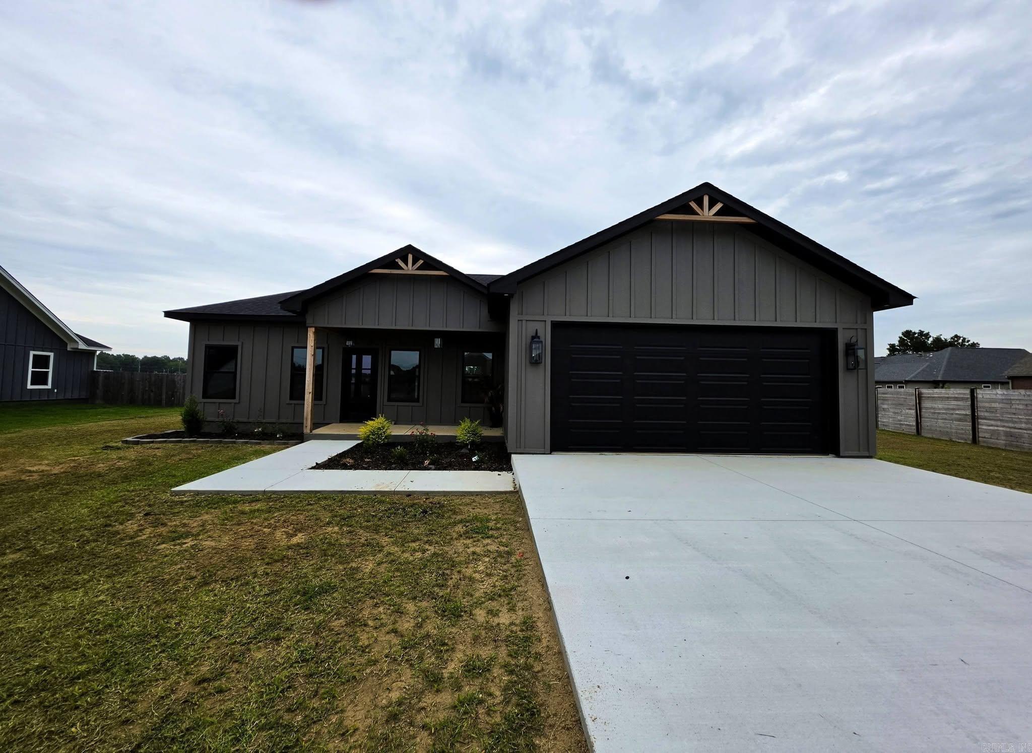 Welcome to this sharp, modern new build right in the heart of Newport. This home grabs your attention the second you pull up with its clean Modern Farmhouse look and LP SmartSide exterior, and a bold dark exterior accented by natural wood porch columns and gable details. It has the kind of curb appeal that stands out.  Inside, you’ll find a bright, open floor plan with polished concrete floors running throughout the entire home. Easy to clean, and great for everyday living. The kitchen is a real highlight, featuring granite countertops, an undermount stainless sink, white shaker cabinets with black hardware, and stainless steel appliances. The oversized walk-in pantry with custom stained-wood shelving gives you all the storage you could want.  The home is finished with custom stained-wood trim and door casings that add warmth and character. Both bathrooms are clean and modern with matching vanities, undermount sinks, tub/shower combos, and black fixtures. The primary suite includes a large walk-in closet with built-ins for easy organization.  If you’re looking for a stylish new build farmhouse look this one could be for you!