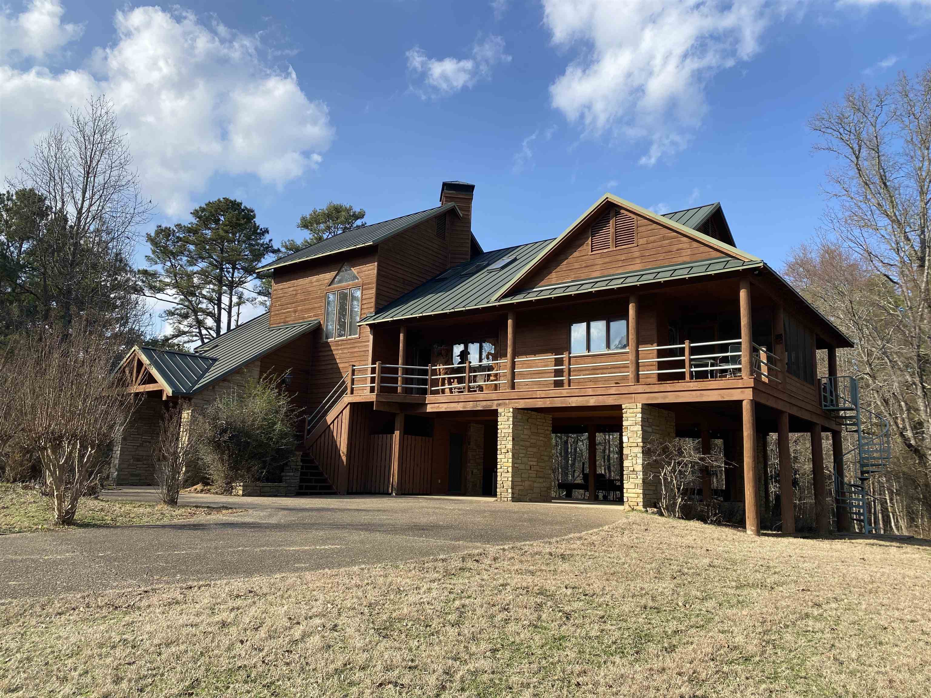 Beautiful Lake Ouachita home located minutes from the boat launching ramp and swimming area at Twin Creek Recreation area.  You will feel the stress melt away the minute you drive through the gate and start up the concrete drive to this 3 level home. 4 bedrooms and 3 1/2 baths, (2966 sq ft) provide all the space and privacy you need for your family and friends. 2 bedrooms, 1 bath located on the first floor, primary bedroom and bath located on the main floor, and the 4th bedroom and bath are located on the 3rd floor.   Main floor of the home has the open concept so everyone is included in the fun with a vaulted wood ceiling, large rock fireplace and lots of windows to bring in that natural light.  Kitchen has bar seating for 6 with plenty of cabinets for storage and a pantry.  Screened deck is located just off the kitchen for that morning coffee and a open deck wraps around to the rear and front of the home. A spiral staircase off the deck takes you down to the grassy area with lots of room for the kids to run and play.  Home sits on 4.03 acres at the top of the hill and backs up to the Corp of Engineers property. This home is a rare find and won't last long! Call today!