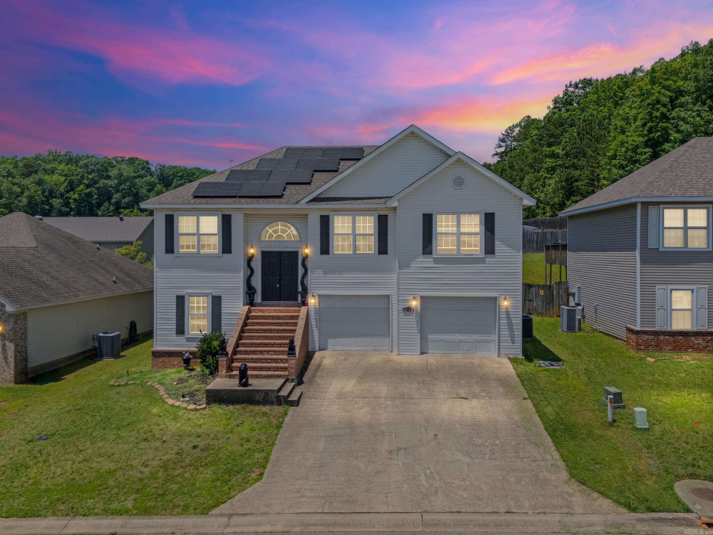 Located on a cul-de-sac in the established Carrington Place subdivision in Alexander, AR, this 3-bedroom, 2-bath split-foyer home offers 1,733 square feet of functional living space. The brick staircase leads to a double-door entry, creating a welcoming first impression.  The main level features a spacious living room that flows into the kitchen and dining area, along with a primary suite featuring a private bath and walk-in closet. Two additional bedrooms and a full bathroom complete the upper level.  Downstairs, you'll find a versatile bonus room, dedicated laundry room, and an oversized two-car garage with additional storage space.  Outside, enjoy a fenced backyard and refurbished deck, providing plenty of room for outdoor living and entertaining.  Recent improvements include a new HVAC system installed in December 2025 and solar panels added in September 2024. The solar panels will be paid off at closing and convey with the property, allowing the new owner to enjoy the benefits of an all-electric home without an additional solar payment.  Conveniently located with access to Bryant, Benton, and Little Rock.