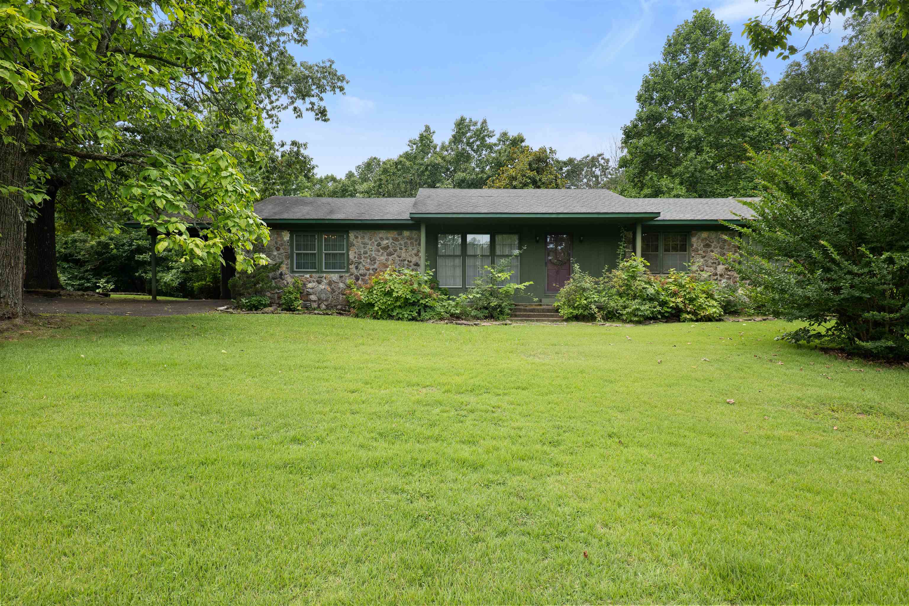 Enjoy the best of country living with the convenience of highway frontage! Situated on 3.5 acres, this 3 bedroom 2 bath home offers over 1,800 sq ft of living space and features a timeless native rock exterior full of character. Inside you’ll find a cozy wood burning fireplace that’s perfect for chilly Arkansas winters and can help reduce heating costs. The kitchen includes a charming vintage propane oven and cooktop. While the home could benefit from some updating, it provides endless potential to make it your own with plenty of yard. Located just 8 minutes from Hardy and approximately one hour close to Jonesboro, you’ll enjoy a peaceful rural setting with easy access to shopping, dining, weekend getaway, Vagabond Lake or an investment  opportunity