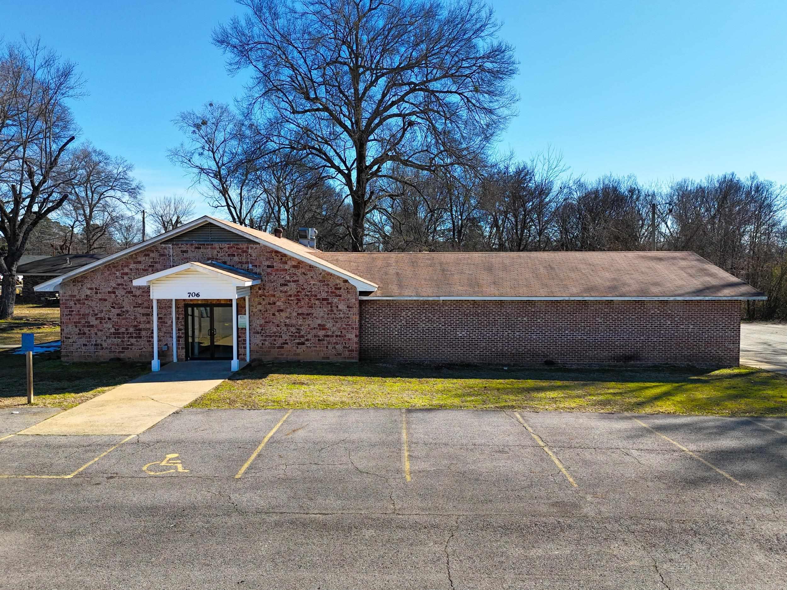 Prime commercial opportunity located just minutes from University of the Ozarks! This versatile property, previously utilized as a church, offers multiple office spaces, spacious gathering areas, and a functional kitchen setup. With over 30 on-site parking spaces, accessibility and convenience are a major advantage for staff, clients, or event attendees. Ideal for professional offices, educational facilities, nonprofit organizations, community use, or redevelopment. The flexible layout allows for a variety of business ventures, all in a high-demand location with strong visibility and growth potential.
