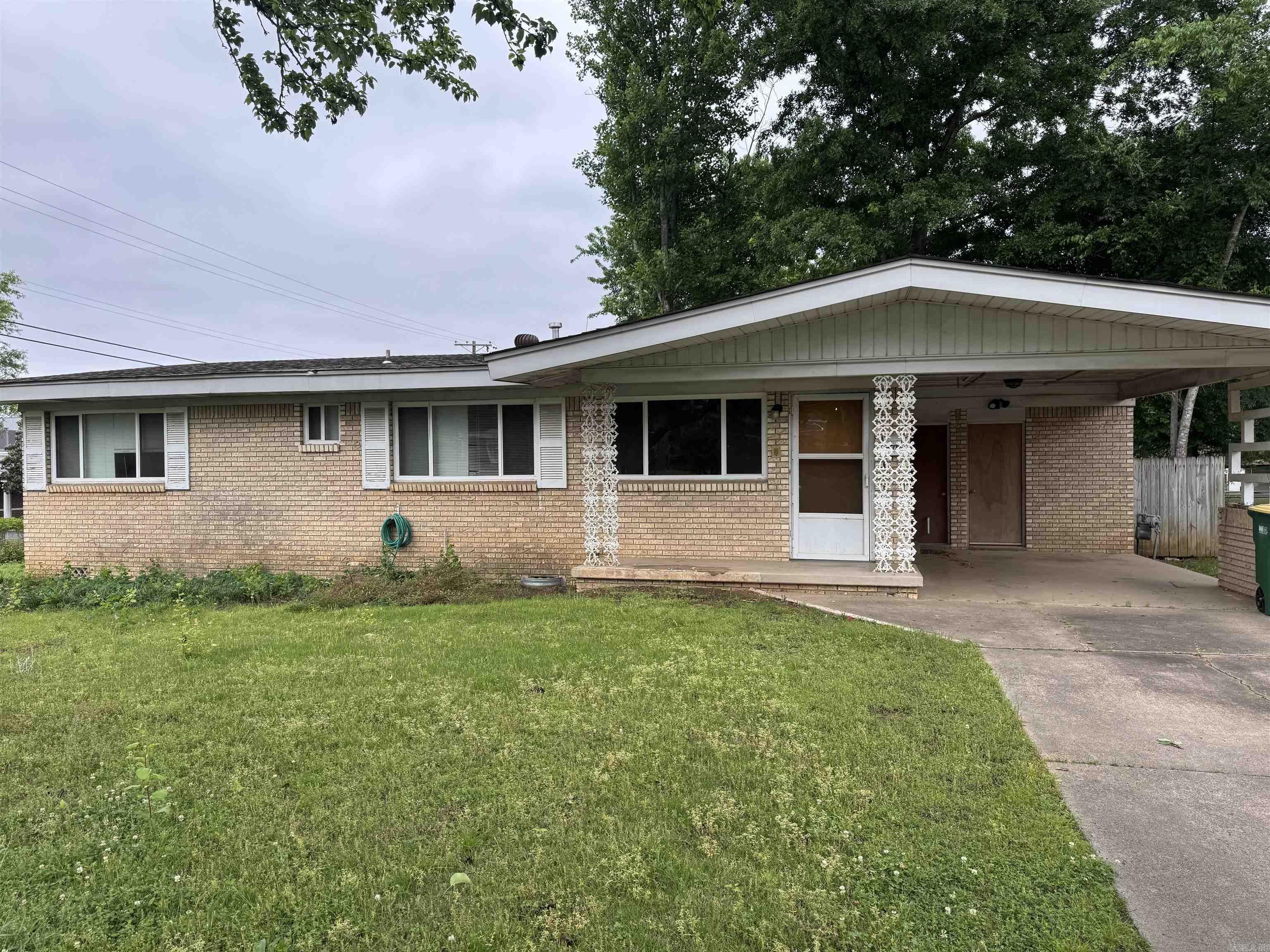 Perfect opportunity for Investor.  Great location for this 3 BR, 1.5 Bath all brick home.  Kitchen has gas stove and refrigerator.  French doors lead out to the covered patio overlooking the level, fenced yard.  Hardwoods can be refinished to look great.  Living room has large windows to let in natural light and it is open to the kitchen.  Laundry room can be accessed from the inside.  One car carport.  Corner lot.  Priced to Sell!!!  More pictures to be added.  Agents See Remarks!