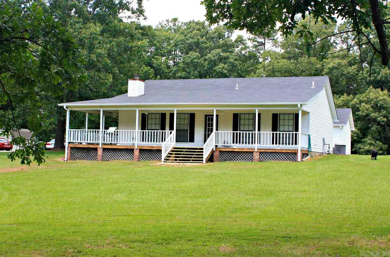 Tranquility awaits.  This 4 bedroom 3 bath home is ready and waiting on a large family with lots of room outside for children to run and play.  Porch wraps down one side and front.  Large master suite added in 2006 with approx 960 square feet, would be great for a Mother-in-law's living space has huge walk in closet with a built in sewing table at the end.  Kitchen has tile counter-tops overlooking the living and dining area with gas log fireplace.  Second bedroom has it's own bath.  Property is fenceline