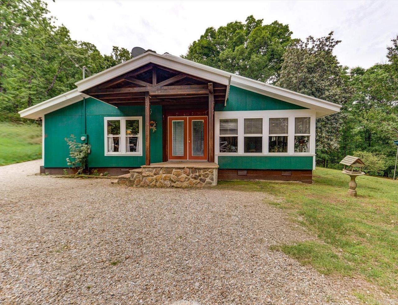 Updated 3-Bedroom Home on 3 Acres with Shop, Barn & Custom Wood Features Near Lake Ouachita  Set on approximately 3 acres, this 3-bedroom, 3-bath home combines recent updates with distinctive wood craftsmanship and functional outdoor space. A new metal roof and double-pane windows were installed in 2025, offering added durability and energy efficiency.  Inside, the home features wood flooring throughout, including oak and hard pine, along with a spruce wood ceiling that adds natural character. The kitchen includes custom cabinet doors crafted from antique cypress, creating a unique focal point. The property is equipped with a 1,200 sq ft shop and a 1,500 sq ft pole barn—both with new metal roofing—providing flexible space for storage, equipment, hobbies, or workshop use.  Located approximately 10 miles from Lake Ouachita marina access and just minutes from Ron Coleman Mining, this property offers convenient access to outdoor recreation, including boating, fishing, and rock hunting. A solid option for buyers seeking acreage, usable outbuildings, and custom wood details in a rural setting.