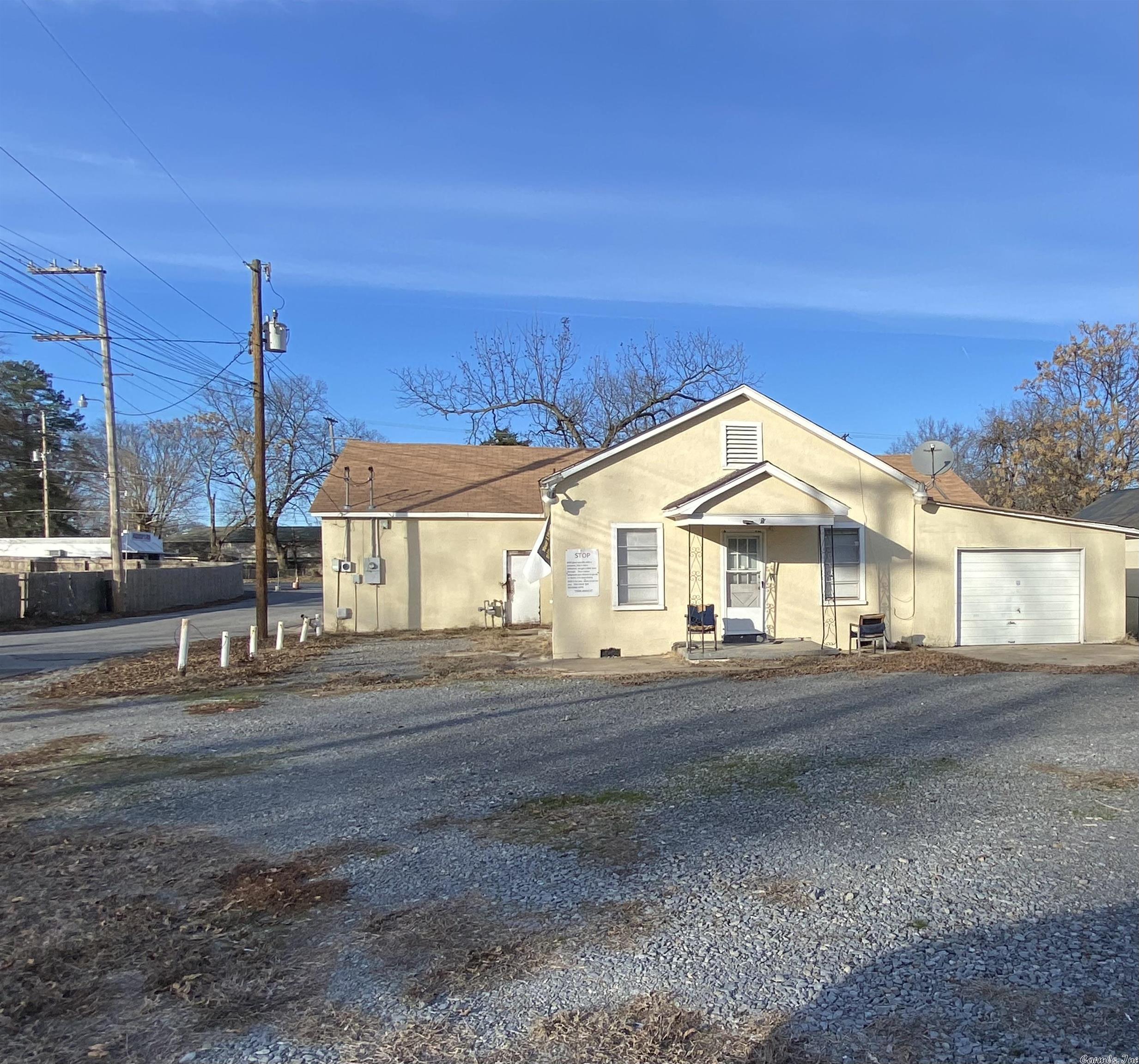 Attention Investors this won't last long! Small living quarters, 672 square feet, and single garage with a huge attached Auto Repair Shop.  The Auto Repair shop is approximately 2084 Square feet.  This can be transformed into other type business space. This property is zoned as C-1. Selling as/is no repairs. Square footage is approximate, measuring is encouraged. Schedule your showing today!