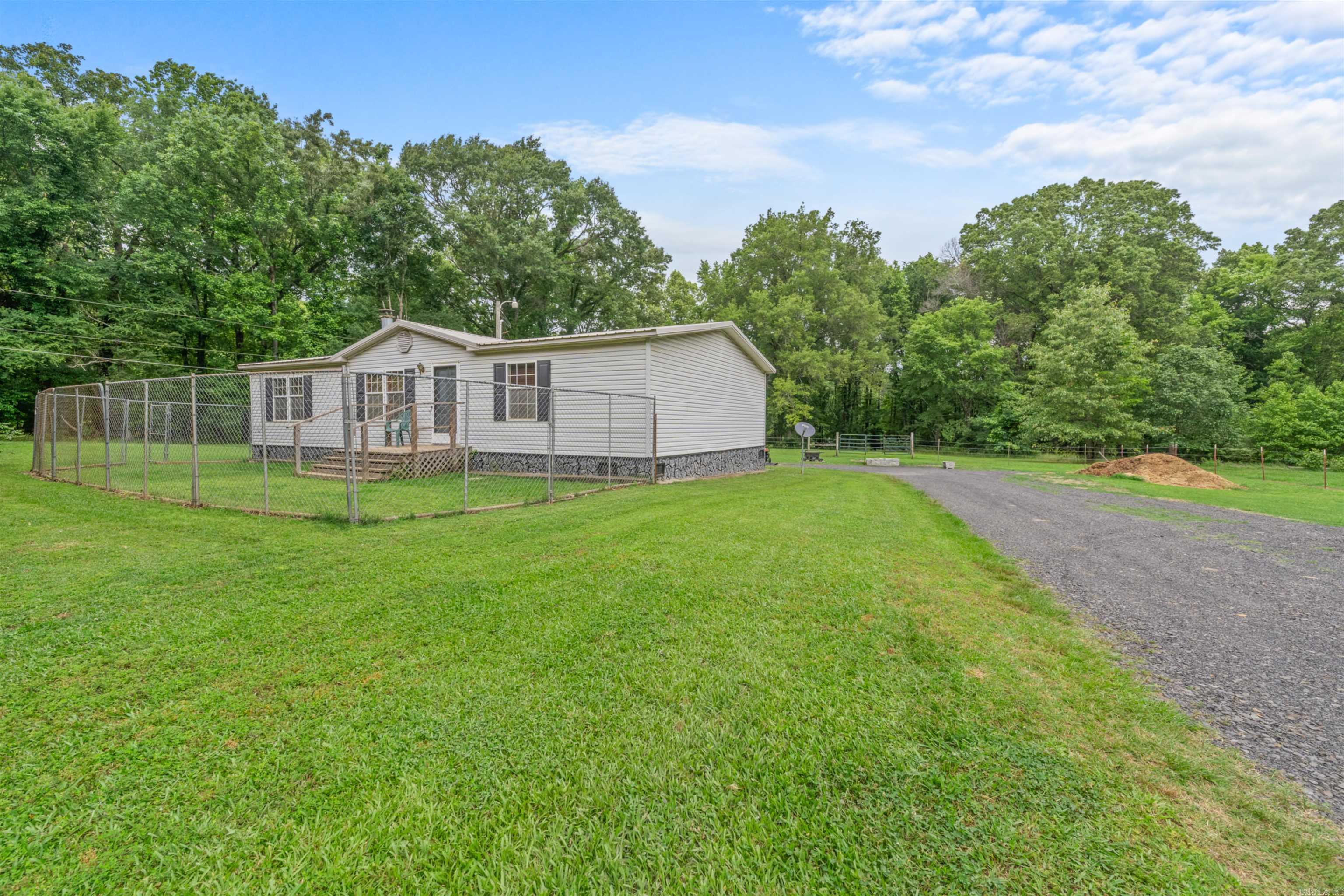 HORSE LOVERS DREAM! Well maintained, one owner 3br/2bath on permanent foundation with nice covered carport/patio area, nestled on 6.5 acres. Property features and impressive 80x100 covered metal riding arena with additional stall space along one the side.-- perfect for training year round.  Also includes another small barn & horse walker.  Home features Newly remodeled primary bathroom with a modern walk in shower. Walk in Closets.  PLUS Storm Shelter.  Grand Prairie Water / First Electric  Set up for young trainer, HOBBY FARM, or any able to enjoy the Large covered area.  #startyourmovetoday