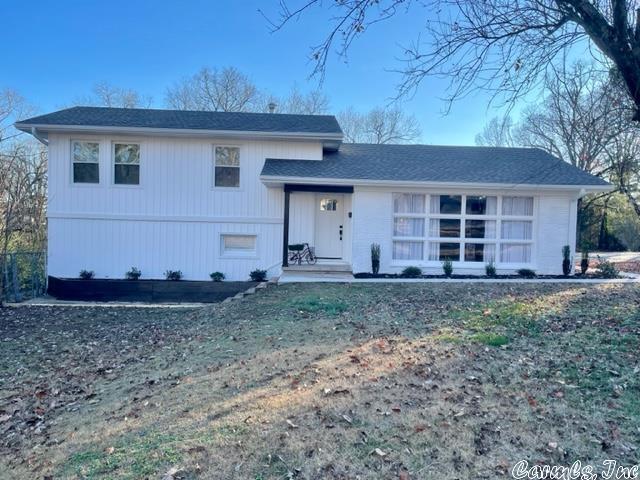 WINNING COMBINATION!! Location, UPDATES and size make this home EASY TO ENJOY! Conveniently located near Lyon College this 3 bedroom, 3 bath home on 4 lots make it MOVE IN READY! Need space for a home office, studio, game-room, or apartment? Look no further!! The warm, cozy living room with a wall of windows says ''stay a while!'' Galley kitchen features stainless steel appliances, new cabinets, appliances and new counters. 26X32 patio could easily fit an outdoor kitchen! A few of the MANY updates completed in 2021-22 are new flooring ,new siding, new shingles, new gutters and sidewalk just to name a few. RUN, don't walk to set up your appointment TODAY!!