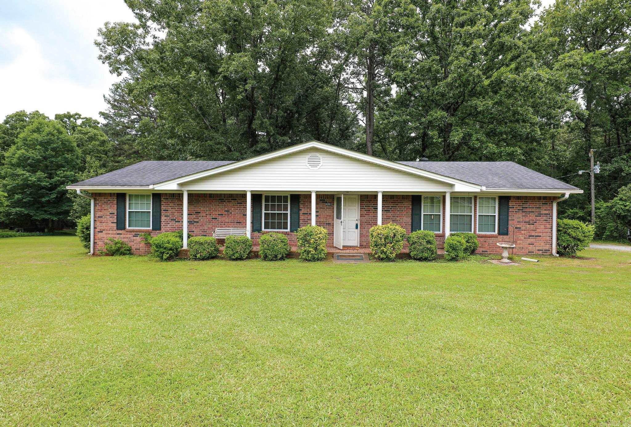 This one owner all brick home offers you all you need in your forever estate! Super neat and clean sturdy older home, acreage to play on, a shop, shed, huge front yard and shaded woods in the back! Three bedrooms and two baths with an open kitchen, large dining, large living room with lots of windows! Spacious laundry with extra closets and room for a frig or freezer. Outside features are the 30x 50 metal shop with heat, a storage shed and boat shed. Front yard is open and lush and the back acreage is wooded. Something for everyone. On a dead end road so little traffic and a great country living feel!  A Really well kept home and grounds that you will fall in love with!