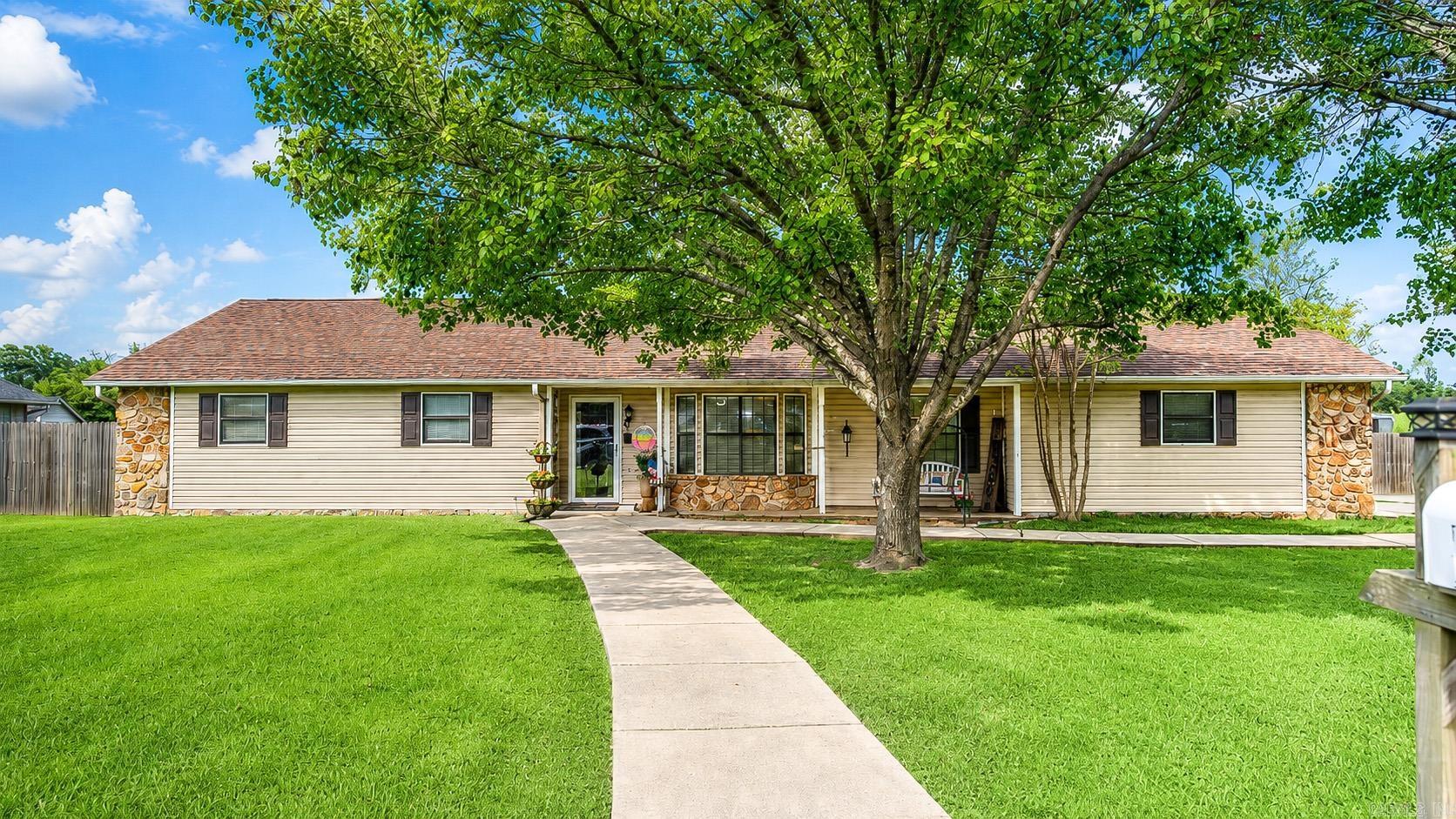 Welcome home to this beautifully remodeled 3-bedroom, 2-bath home featuring modern updates and functional living space. The open floor plan creates an inviting atmosphere, highlighted by a stunning, completely renovated kitchen featuring granite countertops, a stylish tile backsplash, abundant cabinetry, and extensive countertop space—perfect for cooking, entertaining, and everyday living. The spacious primary suite features a brand-new bathroom with a beautifully tiled walk-in shower, tile flooring, and a new vanity. Two separate living areas provide flexibility for entertaining, a home office, or a playroom, while the oversized sunroom offers endless possibilities for relaxing or gathering with family and friends. A dedicated laundry room adds even more convenience. New tile flooring to be installed in laundry. Outside, you'll find exceptional amenities including a 30' x 40' shop with electricity, a 30' x 30' enclosed lean-to, a pergola that remains with the property, and extensive landscaping that enhances the home's curb appeal. Additional features include some newer windows, a roof replaced in 2018, and a whole-home generator that can remain with an acceptable offer.