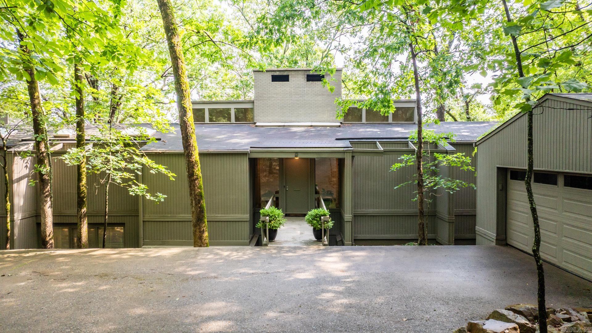 This beautiful home offers fabulous views of the Arkansas River and features spacious indoor and outdoor living. The main level living area has hardwoods, a fireplace, formal dining space and a wall of windows that flood the space with natural light. Enjoy your morning coffee on the deck just off the kitchen, perfectly positioned to take in the incredible view.  The main-level master suite includes his-and-her closets, a cozy sitting area with a fireplace, and vaulted ceiling. Expansive upper and lower decks provide the ideal setting for entertaining or simply relaxing and soaking in the scenery.  Downstairs, a private living area includes two bedrooms, a full bath, and a den that can be closed off from the rest of the home. Additionally, you'll find a spacious second living space with a pool table, another fireplace, wet bar, 4th bedroom (or office), full bath and a heated and cooled workshop — ideal for hobbies or home projects. This home also comes equipped with a generator for added peace of mind.  The carpet has been replaced since pictures were taken... pool table has been professionally disassembled and can convey if buyer is interested.