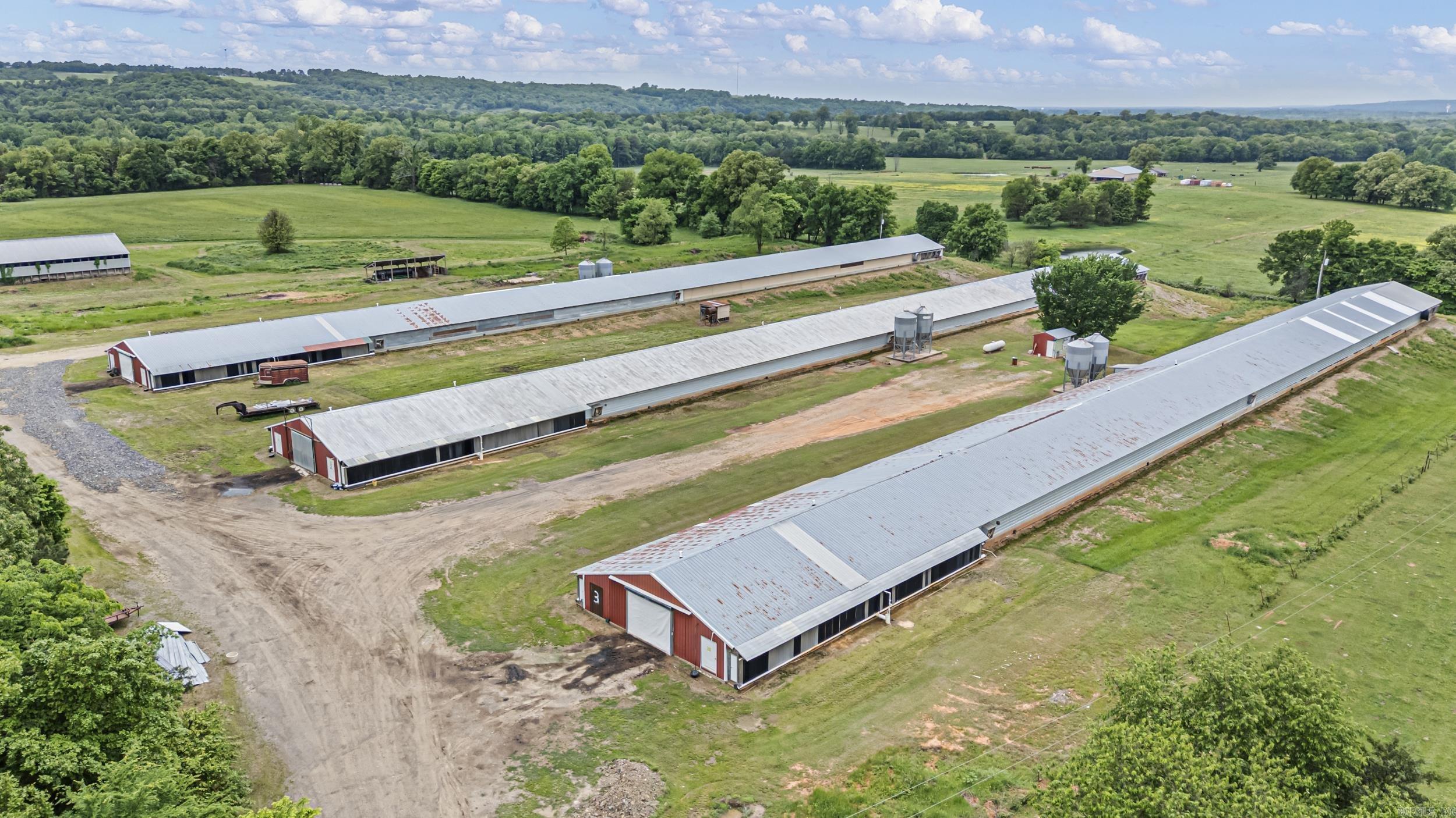Turnkey 3-house Tyson contracted broiler farm on 30± acres in Mulberry, AR! This income-producing operation includes three 40x500 broiler houses built in 1996 under Tyson contract, providing a proven production setup with established integration. Supporting improvements include a 40x60 litter shed and a cattle barn, allowing for additional on-site agricultural income streams or diversified farm use. The property is set on productive acreage with a mix of pasture and usable land, offering partial fencing & room for expansion or additional livestock operations. A pond is also located on the property, adding utility and long-term land value. Strategically positioned for poultry production, this farm presents a strong opportunity for both experienced integrators and investors seeking agricultural cash flow with existing infrastructure in place. Reliable contract history & established farm layout make this a solid addition to an existing portfolio or a strong entry point into the poultry industry.