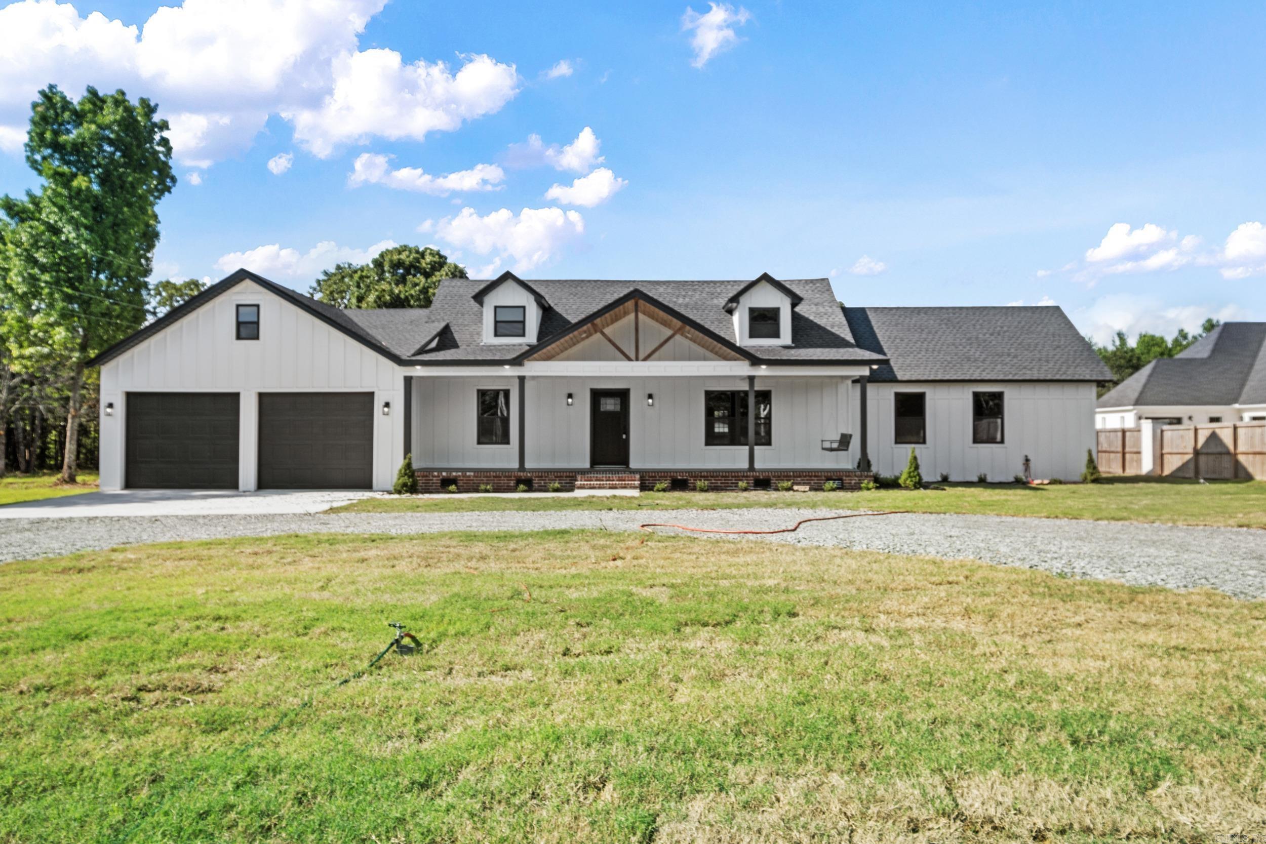 Country living just minutes from town in this newly remodeled home boasting a vaulted, cedar plank ceiling in the open living, kitchen & dining. Perfect for a large family or entertaining! Separate from the other bedrooms you will find the primary suite with beautiful tongue & groove ceiling & a lovely bath with tile shower, soaking tub & walk in closet. Two guest bedrooms & a bath are located downstairs with a separate half bath for guests, laundry & storage closet. Upstairs you will find an additional bedroom & bath. This home has new sheetrock, windows, roof, plumbing, H&A, updated electric, custom cabinets, quartz countertops, appliances & a newly added oversize garage. The 3 acre lot has been cleared & is complete with a shop for added storage!