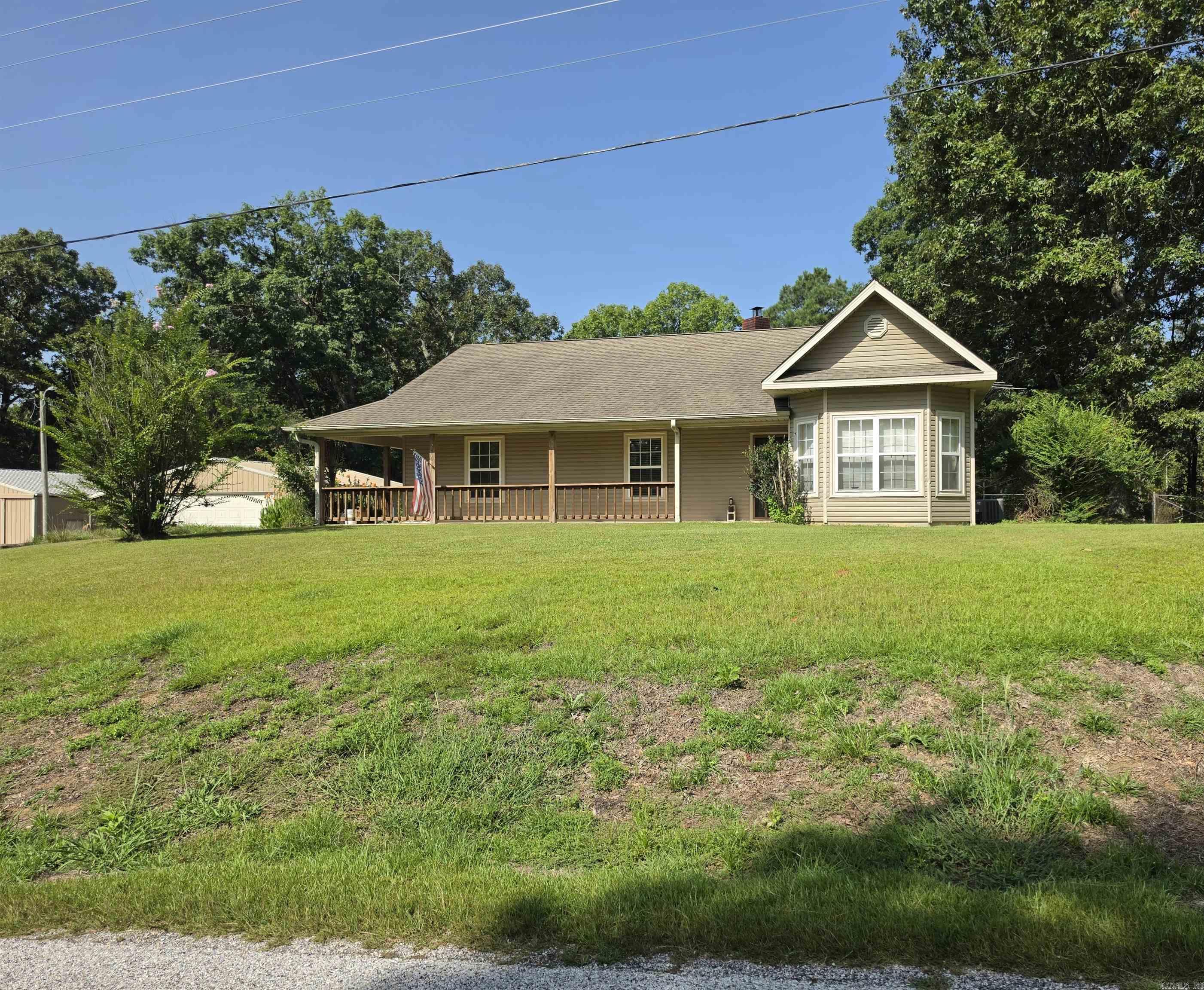 Fisherman's delight in this 3 bedroom, 2 bath home with beautiful hardwood floors in the living and dining room.  It has a woodburning stove in the living which has a vent behind it to the hallway to heat the house if the event of power outage.  Has a covered front porch and also a sweet covered/enclosed back porch area to drop your boots or shoes off.  There is a 12x24 he/she shed for crafting or creativity cabin with a window unit.  There is a 24x30 garage and a 30x30 shop and 2 covered areas or lean-to areas.  The roof was replace in Dec 2016, Hot Water Heater in 2023, Heat Pump was replaced Jan 2019.  Very short distance to 2 Boat ramps on Lake DeGray.  24 minutes to Hot Springs using Hwy 347 a cut through to Harris Rd to Airport Rd. CATC's high-speed internet service with fiber option available in this area