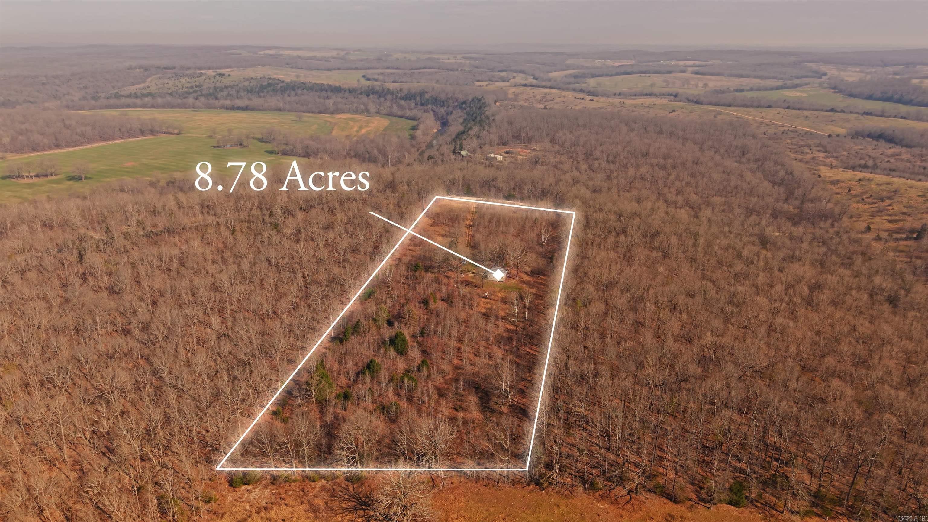 Wooded 8.78 Acres Near the South Fork of the Spring River  This 8.78-acre m/l property offers privacy, natural beauty, and convenient access with a gate at the front to enter and existing driveway leading into the land. The property is mostly wooded and features a small, fairly level clearing near the center, providing an ideal location for building a home, placing a camper, or creating a recreational retreat. A small structure with a metal roof is already on the property and could potentially be repaired for storage or removed depending on your plans. Utilities add to the property's appeal with rural water available, electric already in place, and partial fencing on the land. Located nearby the South Fork of the Spring River, one of the Ozarks’ favorite destinations for fishing, floating, and kayaking. Whether you are looking for a future homesite, seasonal getaway, or recreational property, this acreage offers a peaceful setting close to outdoor adventure.