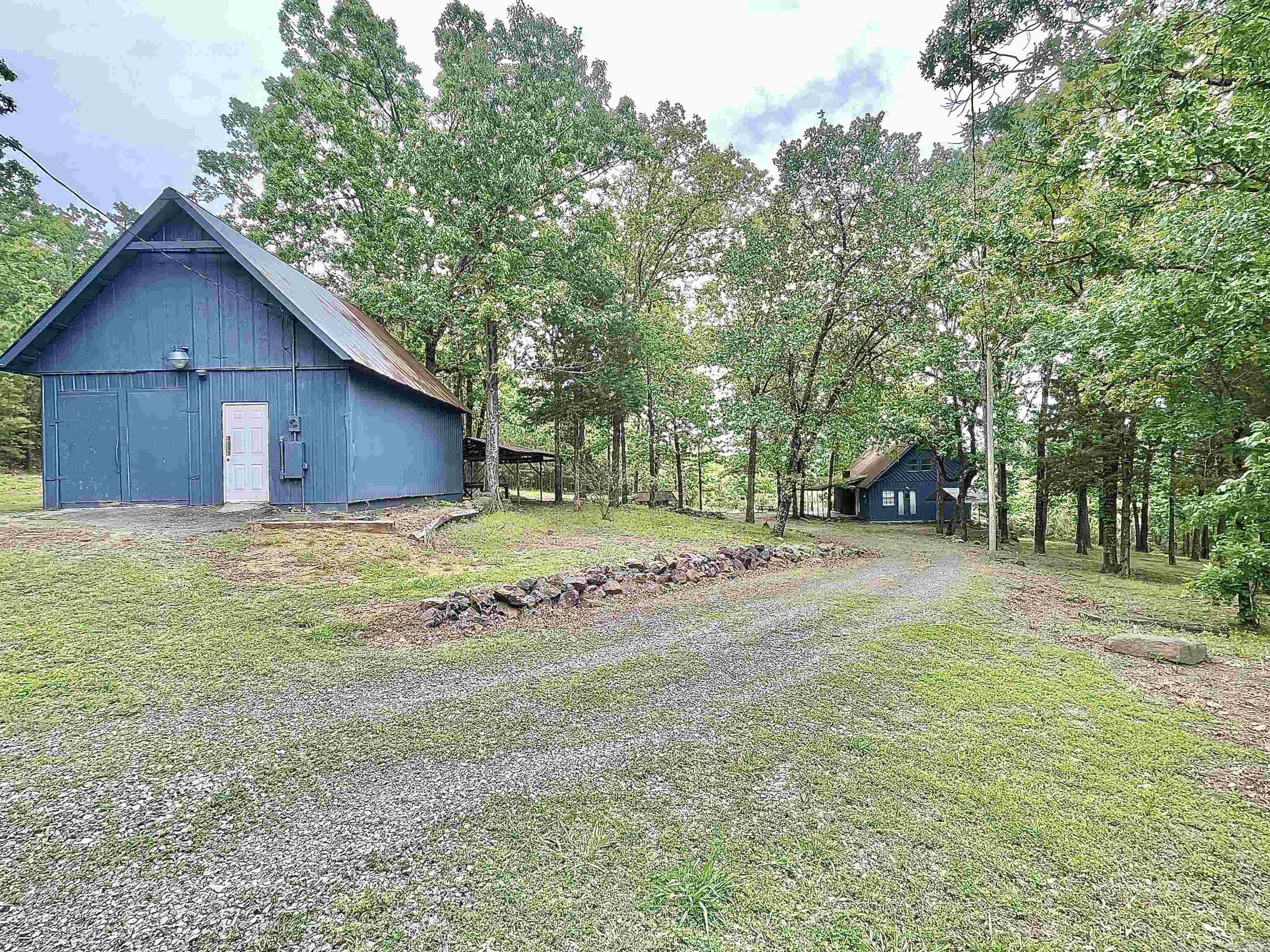 Adorable Cabin in the woods with plenty of privacy , sitting on approx. 4 acres +/-.  Location is amazing with just a short golf cart/SXS ride to Lacey's Marina (only 1.4 miles from the property). Main floor has one bedroom, one full bath, laundry room (washer & dryer stay), living room & Kitchen with all appliances staying.  2nd floor has two bedrooms & one full bath. There is a cozy covered Front porch, storm shelter, & a 20x30 detached garage for your lake toys/hunting gear (garage Being Sold As-Is)!  There are pretty mountain views in the winter & fall.