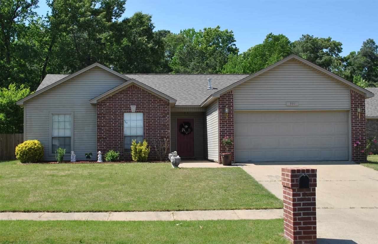 ADORABLE HOME!!  Are you looking for something that is move in ready?  This home has new interior paint, new hand scraped wood floors and new carpet!!  This three bedroom two bath home features a gas log fireplace in the spacious living room, a laundry room, his and her walk in closets in the master bath,  tile flooring in all of the wet areas, an oversized back yard which is privacy fenced and features a patio and a deck and much, much more.   This home is a must see!