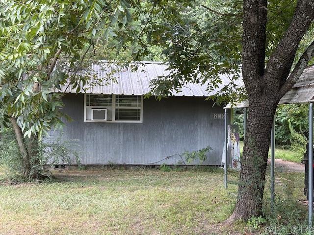 JUST REDUCED! Large single room with a divider for a sleeping area. Bathroom with a shower stall. Heating and air conditioning provided by a window mounted heat pump, new in 2024 and 2 small electric space heaters. Rear porch. Large carport able to accommodate a boat and car. Over a half-acre of land, a utility building and a fenced rear yard. Property includes a hard wood table, a small microwave, a small dishwasher, a 3 burner propane stove and some dishes, a coffee maker and silverware. Two large area rugs convey. There is a small chest freezer on the rear porch and a self-propelled lawn mower.   Although Conway Lake has been drained the renovation project is on schedule and even may be ahead of schedule. Update information is available at: https://www.agfc.com/resources/habitat-and-access-improvement/lake-conway-renovation-project-2/ There is a small inlet at the rear of the property that fills with water when the lake is full and may benefit from the lake improvements and allow access to the lake when completed. NOTE: The value of this property is in the land which can be improved with a larger structure with County approval.