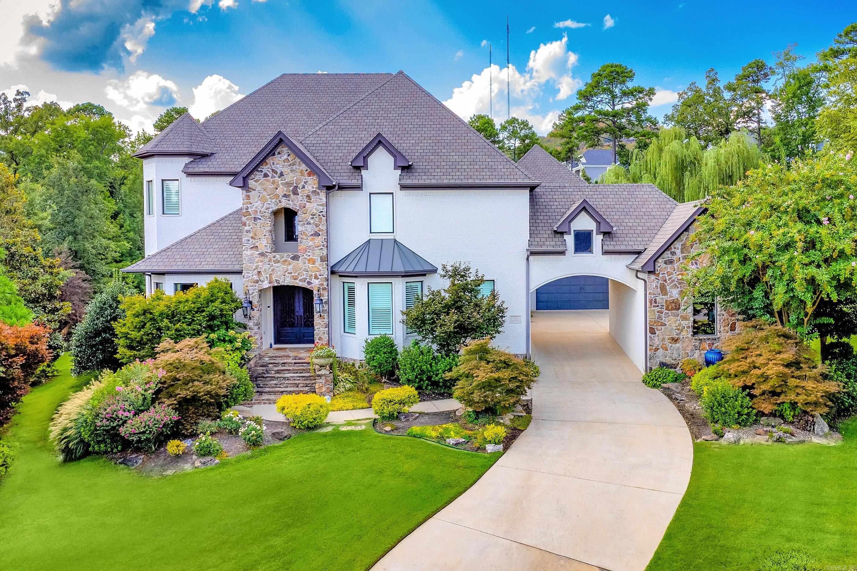 Situated on a beautifully landscaped lot in the coveted gated community of Deauville, this home offers luxury, comfort, and a perfect blend of indoor and outdoor living. Step inside to warm hardwood floors, soaring ceilings, and expansive windows that frame views of the covered outdoor living space, sparkling pool, lush gardens, and backyard pond. The perfectly designed floor plan includes: Great room plus both formal and informal dining areas, Chef’s kitchen with high-end appliances, gorgeous new countertops, and a stylish backsplash Private study and separate office for ultimate work-from-home flexibility Luxurious primary suite with a sitting area, spa-like bath, and massive closet Main-level guest suite with access to pool and patio Theater room with wet bar, new seating, carpet, and screen Custom wine room for the enthusiast Upstairs: two spacious guest bedrooms with shared bath, an en-suite bedroom, and  Additional highlights include: Three-car garage + golf cart storage Custom shades & plantation shutters Upgraded lighting and security system Added hardwoods throughout (no carpet) New pool heater, lights, and liner.  Refined living at its best.  COME SEE!!