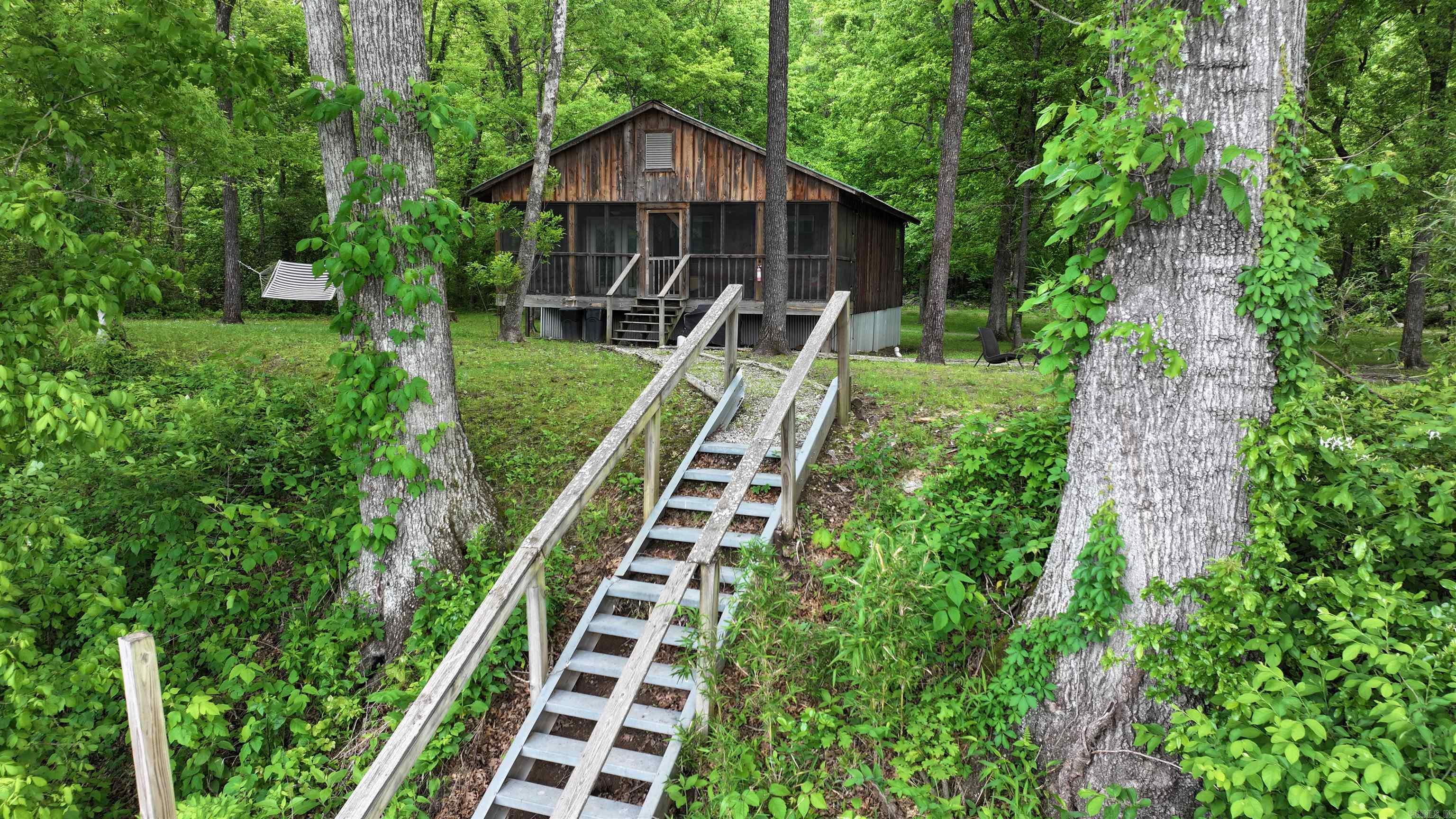 Located just outside of the quaint river town of Calico Rock you will find 1194 Sadieville Road (a.k.a.) Trails End cabin tucked along the banks of the world-renowned White River, this charming river cabin offers the perfect blend of privacy, scenery and outdoor adventure in the heart of the Ozark Mountains.  Wake up to the soothing sounds of nature and enjoy breathtaking river and mountain views right from your door step. Walk outside and your just feet away from some of the best trout fishing in the country.   This cozy 2 bedroom 1 bath retreat is ideal for weekend getaways, a vacation rental or a peaceful full time escape. Cabin is being sold fully furnished  Contact Ricky Harris 901-870-7216 for a fully guided tour.