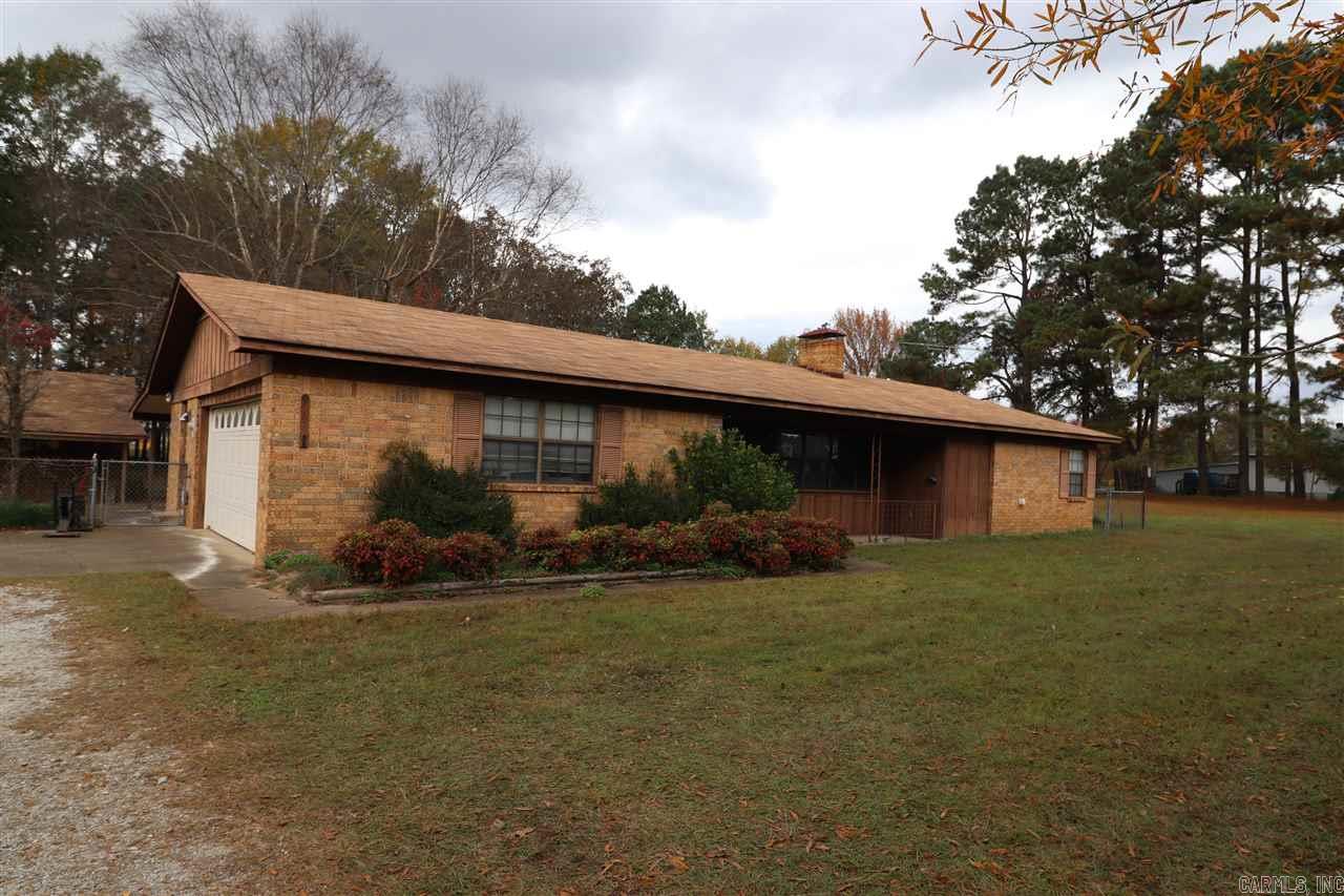 Adorable home located on 1.5 acres in town.  Located close to Interstate without all the business of the main streets.  The home is completely tile floors throughout. Separate laundry room, WBFP, Vaulted ceiling in living room, kitchen dining combo and double car garage.  Back yard has chain-link fence and 20X22 foot detached garage/shop building, covered parking for camper and large open field next to home.  Should be fine for RD, FHA or VA financing.
