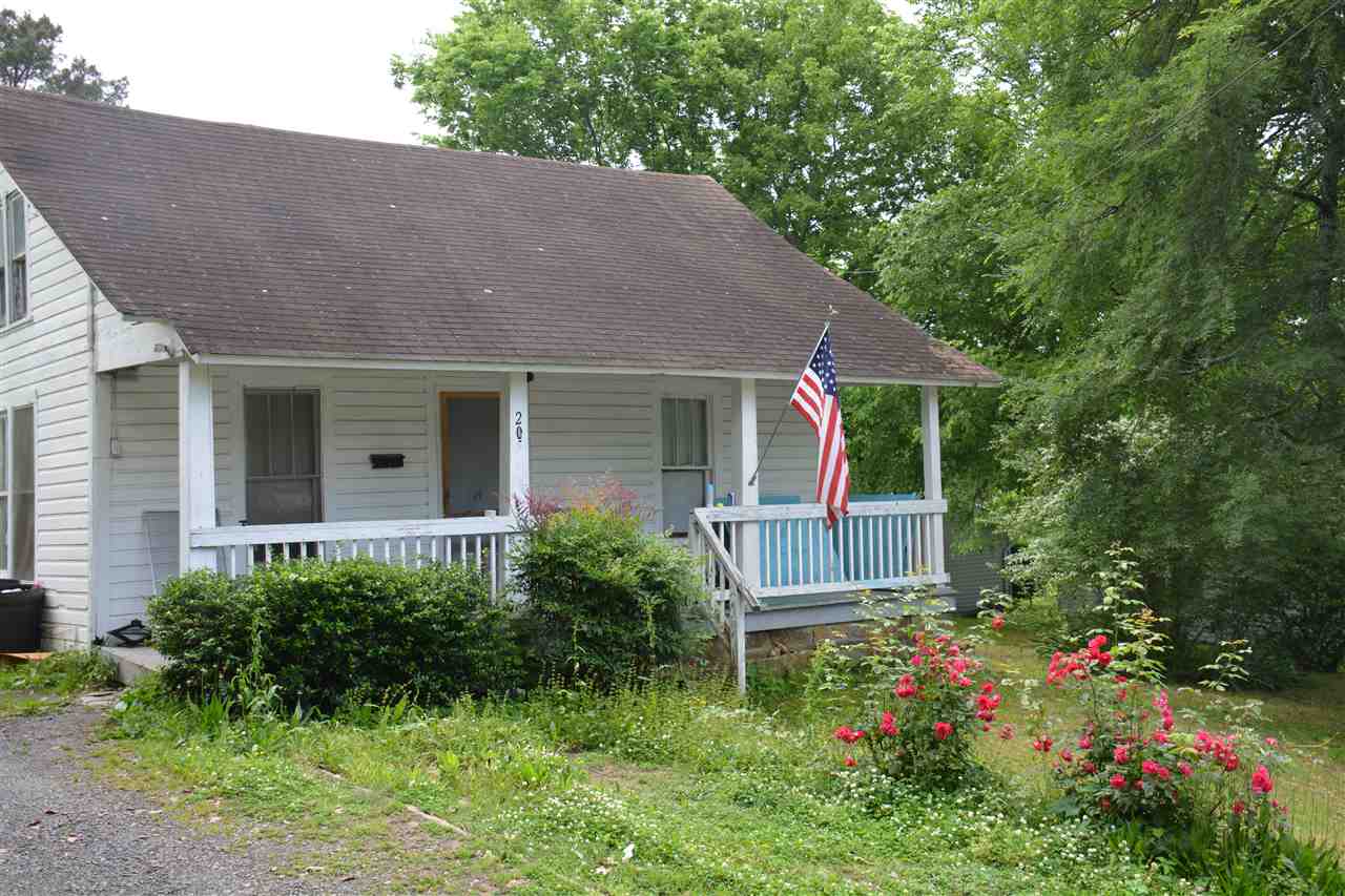Two bedroom home with finished attic bonus room. Separate dining room. Front door, laminate and carpet floor coverings replaced fall of 2011. Heating and air new in 2010. Covered front and back porches. Storm cellar and two storage buildings. Excellent rental property. currently rents for $400 per month
