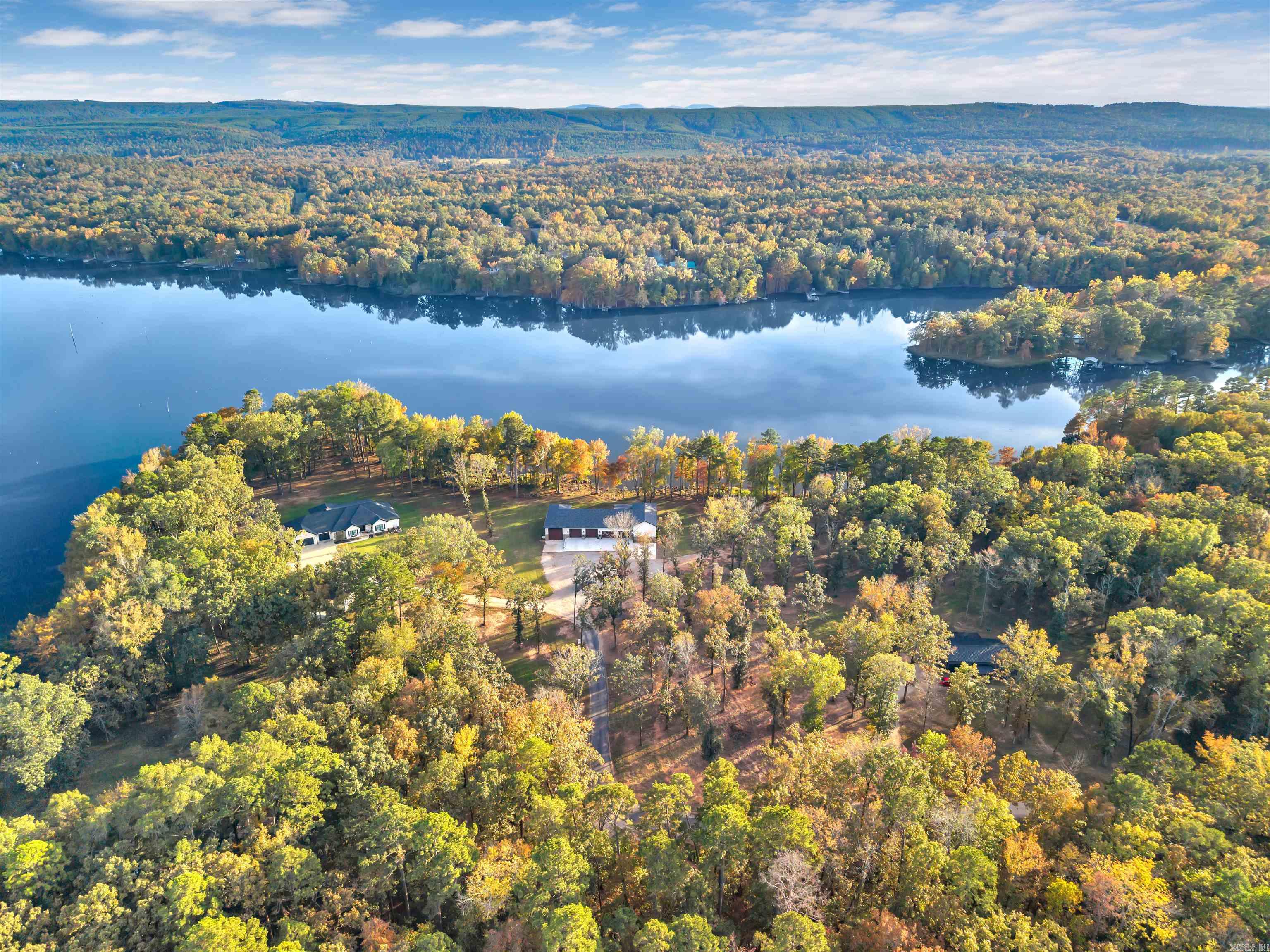 This stunning Harris Brake lakefront property is truly one of a kind and must be seen to be fully appreciated! Sitting on 3 beautiful acres with approximately 500 feet of lake frontage, this serene retreat is surrounded by new custom-built homes in a quiet rural subdivision—tucked far away from the main road for ultimate privacy and peace.  This property is perfect for the retired traveler, who needs a place to call home and wants a place to park their motor home while taking time off the road - with a build site for a guest cottage or main home already set! All utilities are easily accessible and setup in place to hook up to with ease.  The existing house/shop combination features 3 bedrooms, 1 bathroom, and gorgeous custom finishes throughout. The spacious living room showcases tall ceilings and a tasteful blend of modern design with rustic barnwood and stone accents.  The attached shop is a dream setup, featuring three 8’ motorized garage doors, two 10’ manual garage doors, and a 14x14’ door designed in mind for your RV. The back porch is prewired for a hot tub, and there’s even an RV hookup along the side of the home—perfect for visiting friends or family!  Buyer can add dock.