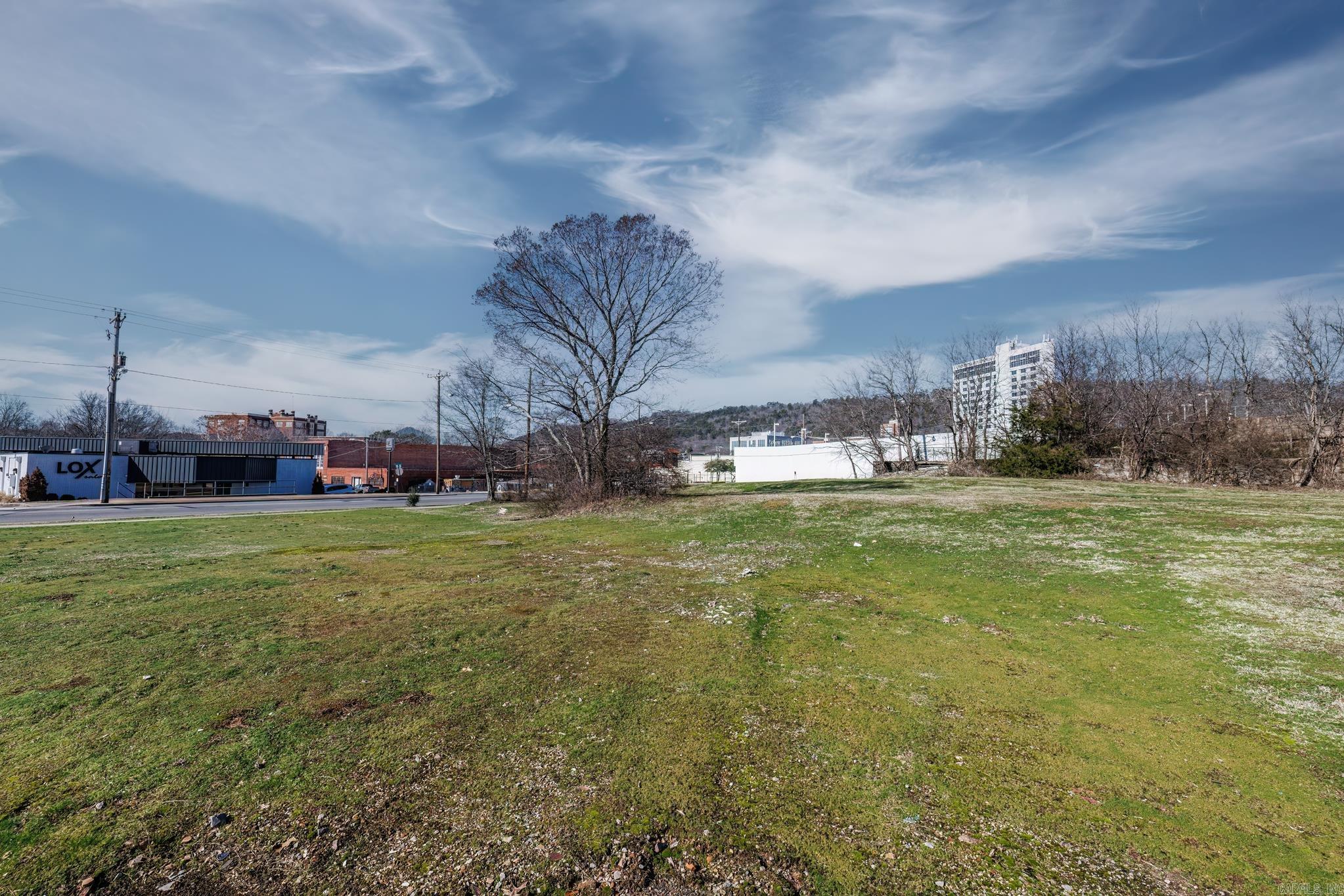 This buildable corner lot in downtown Hot Springs, Arkansas is perfect for commercial development. Situated on over one acre of land, the lot is strategically located on the corner of Malvern Ave and Gulpha Street, just one block away from the popular Hot Springs Convention Center.  With its high visibility and heavy foot traffic, this property offers a prime commercial location. It is conveniently located just a few blocks away from the historic Bathhouse Row, adding to its appeal and potential for success.  The lot is zoned as C-1, making it highly sought after for various commercial purposes. Permitted uses for this property include, but are not limited to, restaurants, spas, retail shops, and office spaces. The possibilities are endless, allowing entrepreneurs and investors to put their own creative spin on the property and cater to the diverse needs of the downtown area.  Whether you're looking to establish a new business or expand an existing one, this buildable lot provides an exceptional opportunity to tap into the thriving downtown market of Hot Springs, Arkansas. Don't miss out on the chance to be a part of this vibrant and historic community.