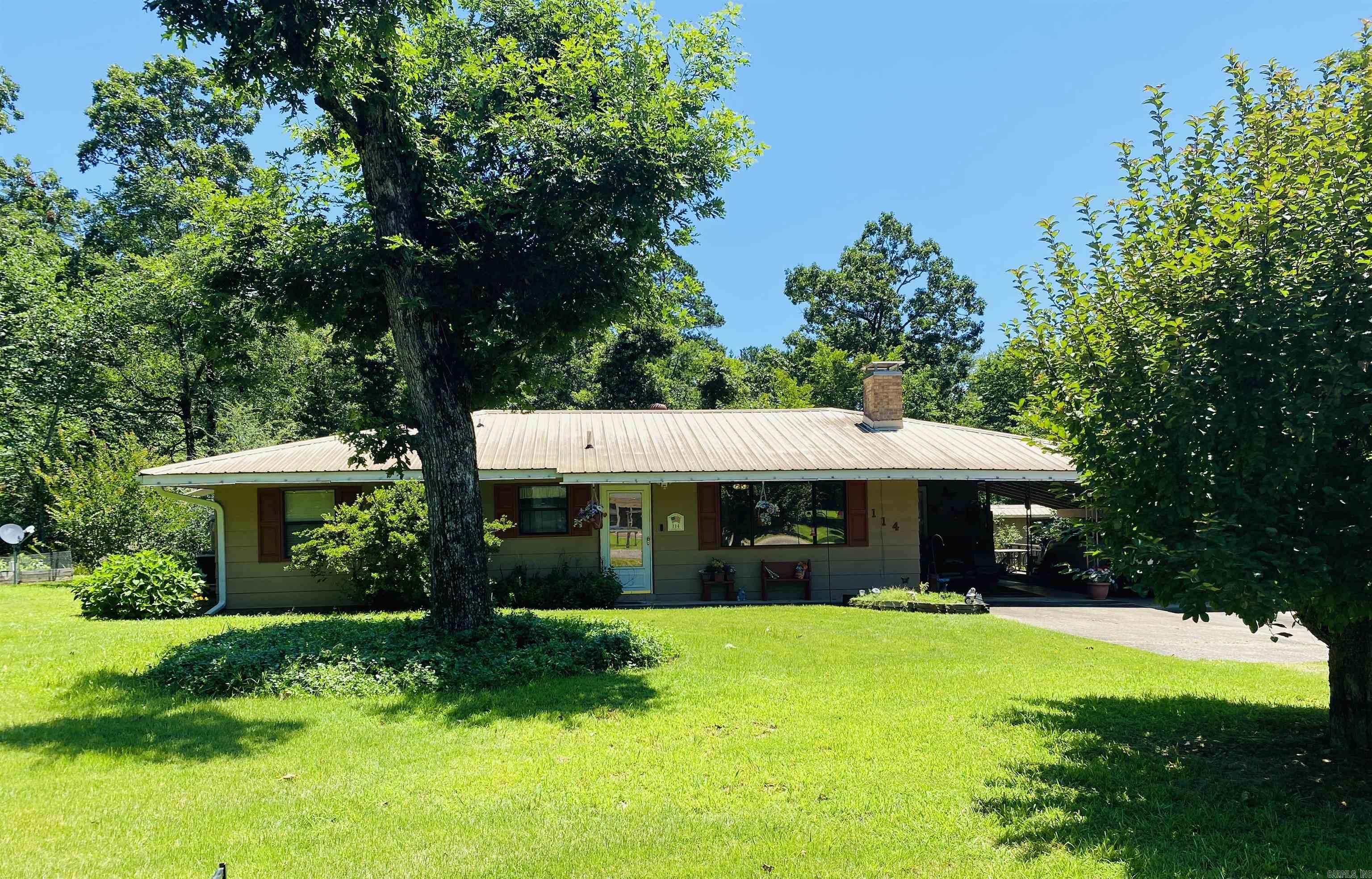 Adorable traditional home with double carport, fenced in backyard and patio with cover. Home features 3 bedrooms, 2 contain French doors, spacious laundry room with built in pantry. Bathroom in primary has double sinks and a walk-in shower that is handicap accessible. Plus there are 2 ramp entrances to the home. Main bath has tub/shower combo with handles. Living room is spacious and has picture window that overlooks the landscaped yard. Nice wood-burning fireplace and built-ins as well. 2 doggy doors with sensory lights over them.