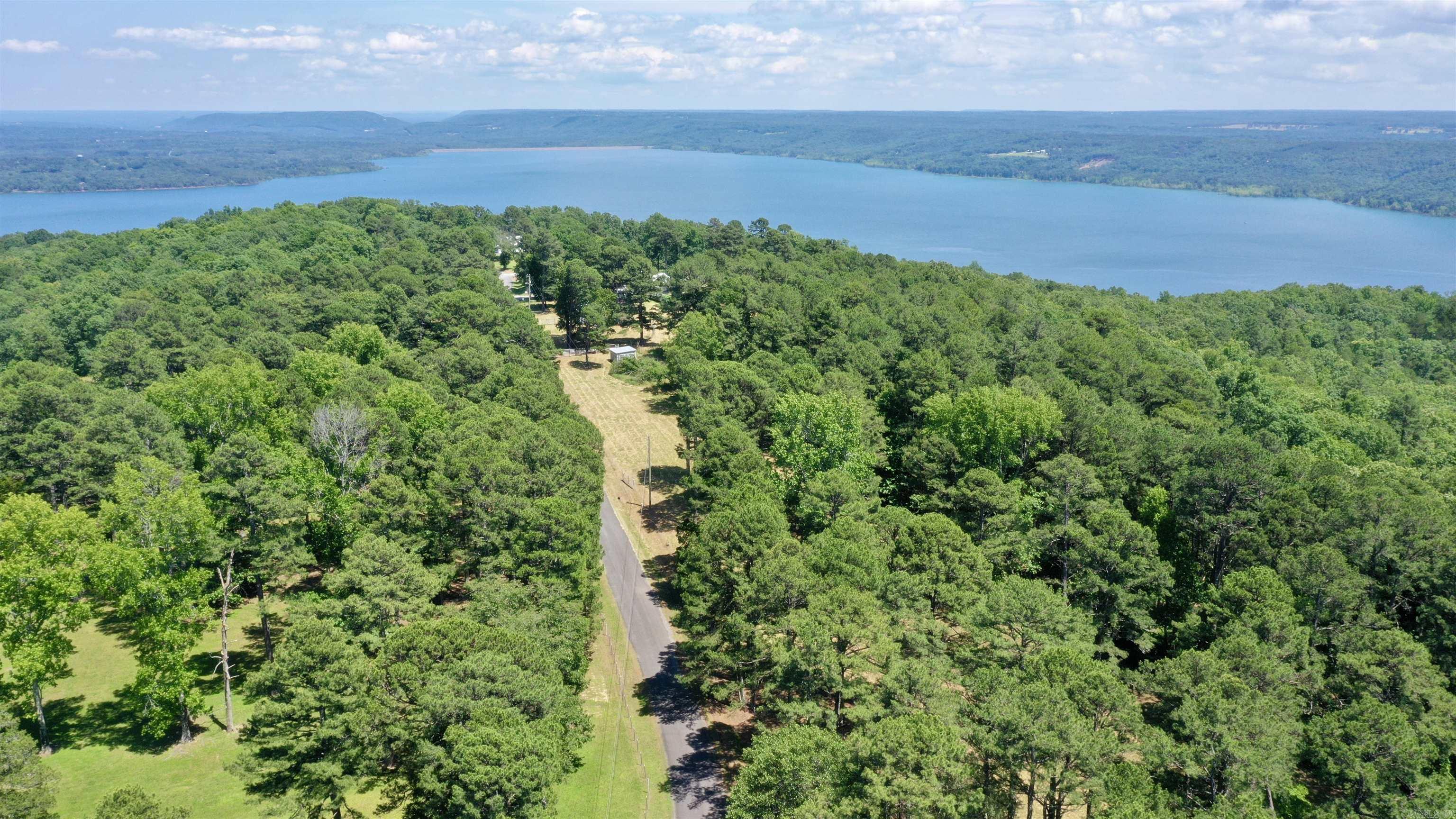 Discover the ideal setting for your dream home on this 5.65-acre property overlooking Greers Ferry Lake and the surrounding mountains. Offering a rare blend of usable acreage and lake views, this lot provides both privacy and convenience. Electricity is already on the property, and water is available at the road, making it ready for your vision to take shape. Located less than 20 minutes from Quitman Public Schools, just 6 minutes from Miller Point Boat Launch, and approximately 20 minutes from Sugarloaf Marina, you’ll have quick access to boating, fishing, and everything Greers Ferry Lake has to offer while still enjoying country living. Come walk the property and experience it for yourself. See drone video Link: https://youtu.be/QgX92JnqqCI