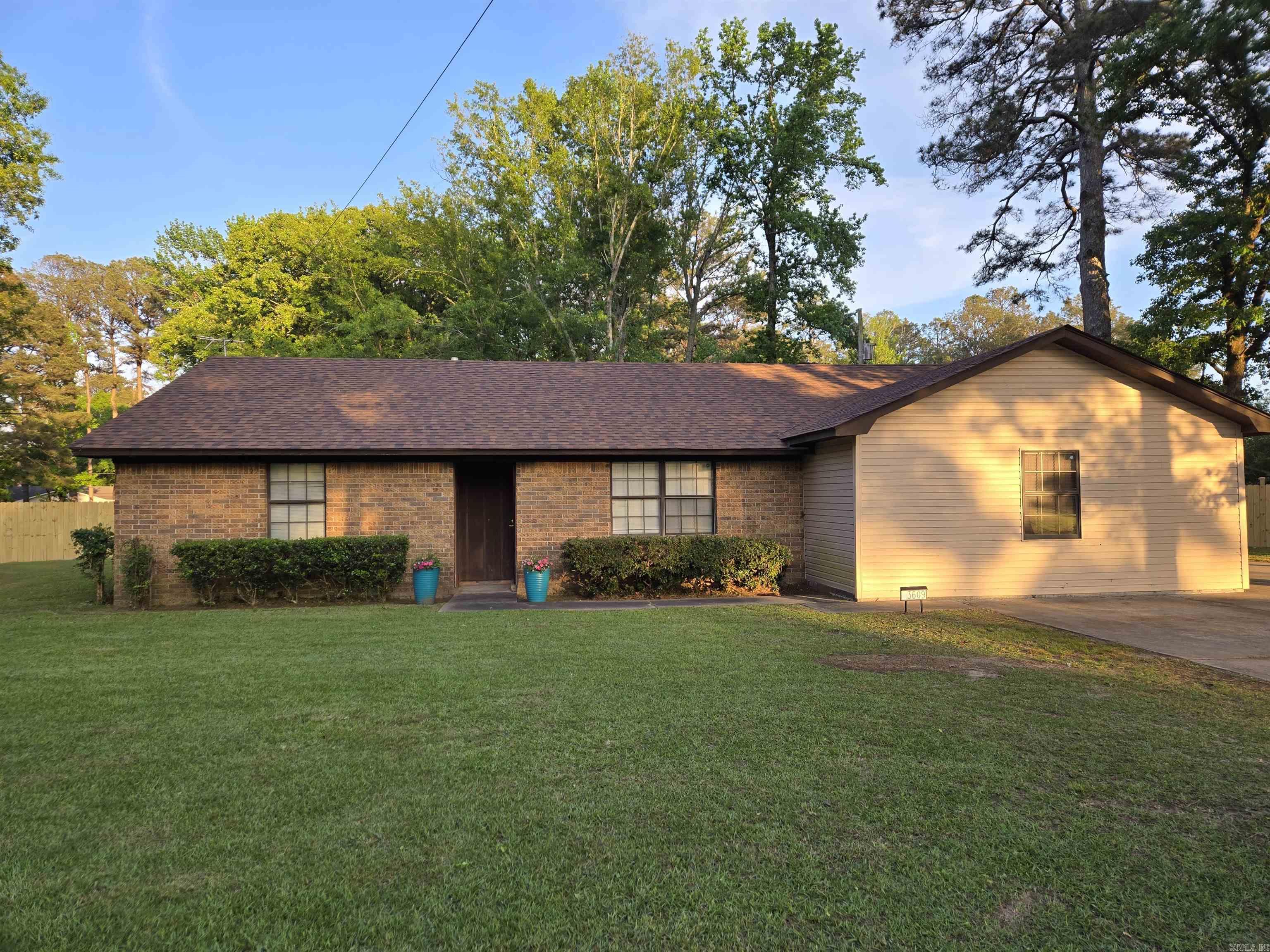 Welcome home to this beautifully maintained 3-bedroom, 1¾-bath home offering 1,956 sq ft on a spacious ½-acre lot. Enjoy a split-bedroom floor plan for added privacy, plus a large primary suite with an electric fireplace and a walk-in closet. The inviting eat-in kitchen includes a large pantry, plus a separate dining room with a charming bay window. A dedicated work area with a rustic fireplace is perfect for remote work or a cozy flex space, along with a convenient laundry area.  Step outside to your private backyard oasis with a new cedar fence and a large deck ideal for entertaining or relaxing. Additional updates include a new roof. Conveniently located near Hwy 530, JRMC, Pine Bluff Country Club, shopping, and dining, this home offers the perfect blend of comfort, space, and location.