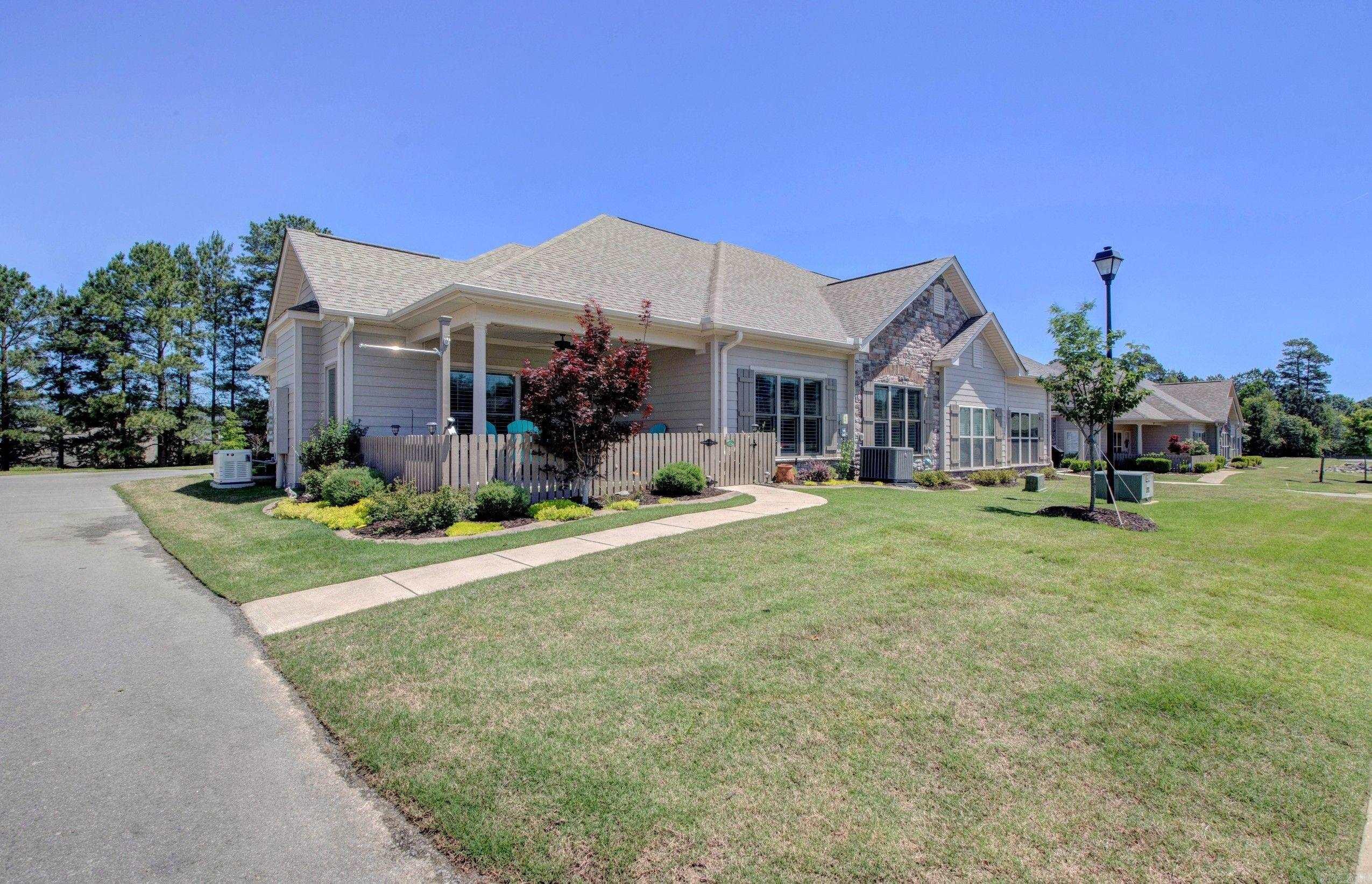 Welcome to Mountain Terrace Estates where living is easier.  HOA takes care of all lawn care, annual cleaning out of gutters, painting of exterior, termite policy, roof maintenance and replacement when needed, and a big part of the homeowner insurance.  A community of mostly single level townhomes with community club house with social activities, in ground pool, club room, and work out facility.  Travel, come and go while someone else takes care of the chores of home ownership, enjoy life more.  This home has fully covered porch with custom roller shades, concrete edging and extra landscaping.   A whole house generator brings piece of mind during storms.  Slab granite in kitchen and baths, five burner gas stove for the chef, rich wood flooring, gas fireplace in great room, plantation shutters throughout allow privacy and natural light at the same time.  Owners suite includes large walk in closet, oversized shower, extra long double vanity.  New replacement windows bring higher level of energy efficiency and comfort.  Come, see, learn how you too can enjoy life more in a community where home ownership still allows freedom to live as you wish.