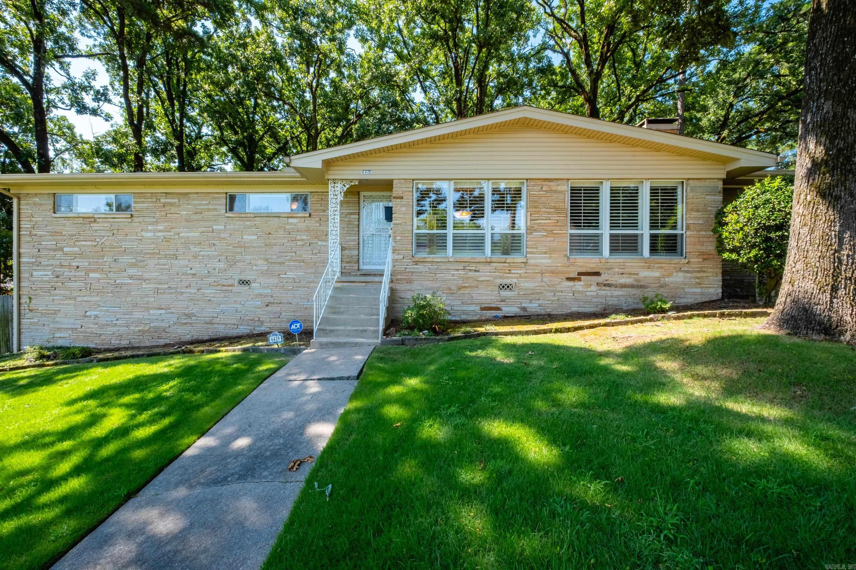 Well-maintained home on a corner lot in Midtown. Features beautiful hardwoods, carpet, and tile flooring, with tile in kitchen and baths. Flexible formal dining room may also serve as a second living area. Den includes fireplace and built-ins. Three bedrooms and two full baths, including one with walk-in shower. Kitchen offers breakfast bar and breakfast nook. Enjoy a park-like backyard with covered porch, flat stone patio, and mature shade trees. Two-car side-entry carport provides convenient access.