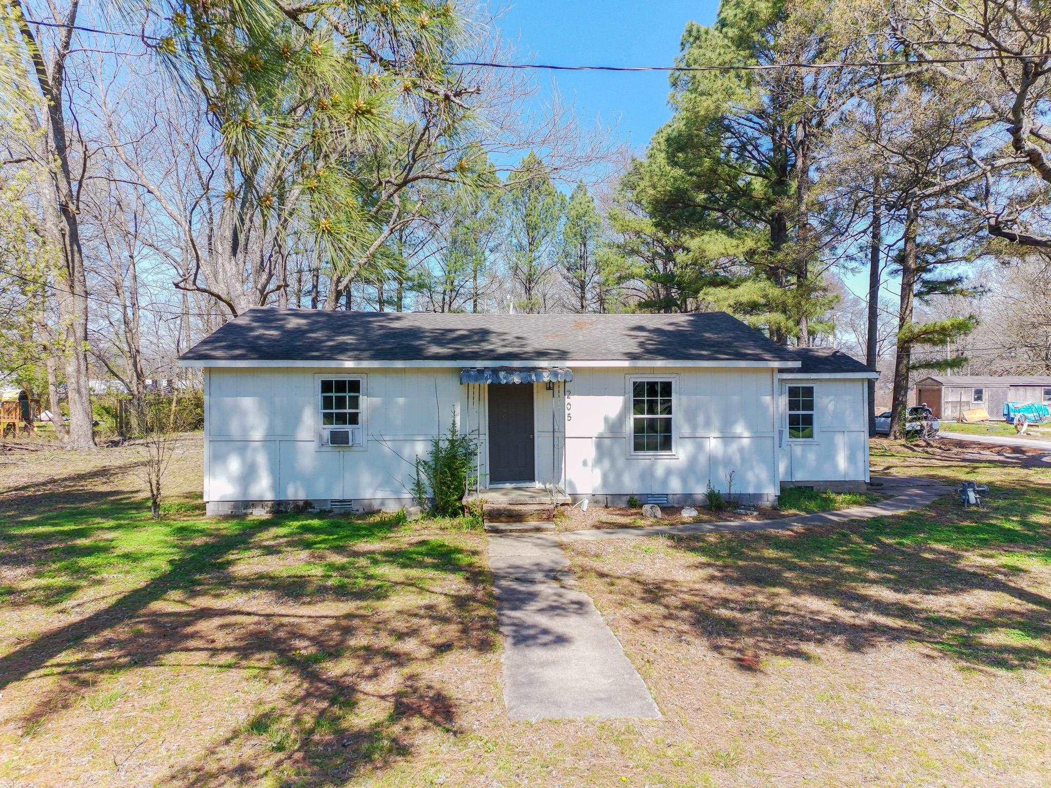 Welcome to 205 E Matthews. This 2 bedroom, 1 bath home offers 1,141 SF of living space and sits on nearly half an acre offering a spacious lot with mature shade trees and a storm shelter out back for added peace of mind. Inside, the home features a gas stove, gas heat, window units, and washer and dryer hookups. An additional room provides flexibility and can easily function as a third bedroom, office, or bonus space. Previously rented for $950 per month, this property presents a solid opportunity for investors looking to generate cash flow or expand their portfolio. With its lot size and layout flexibility, there is also potential for future improvements or increased returns.