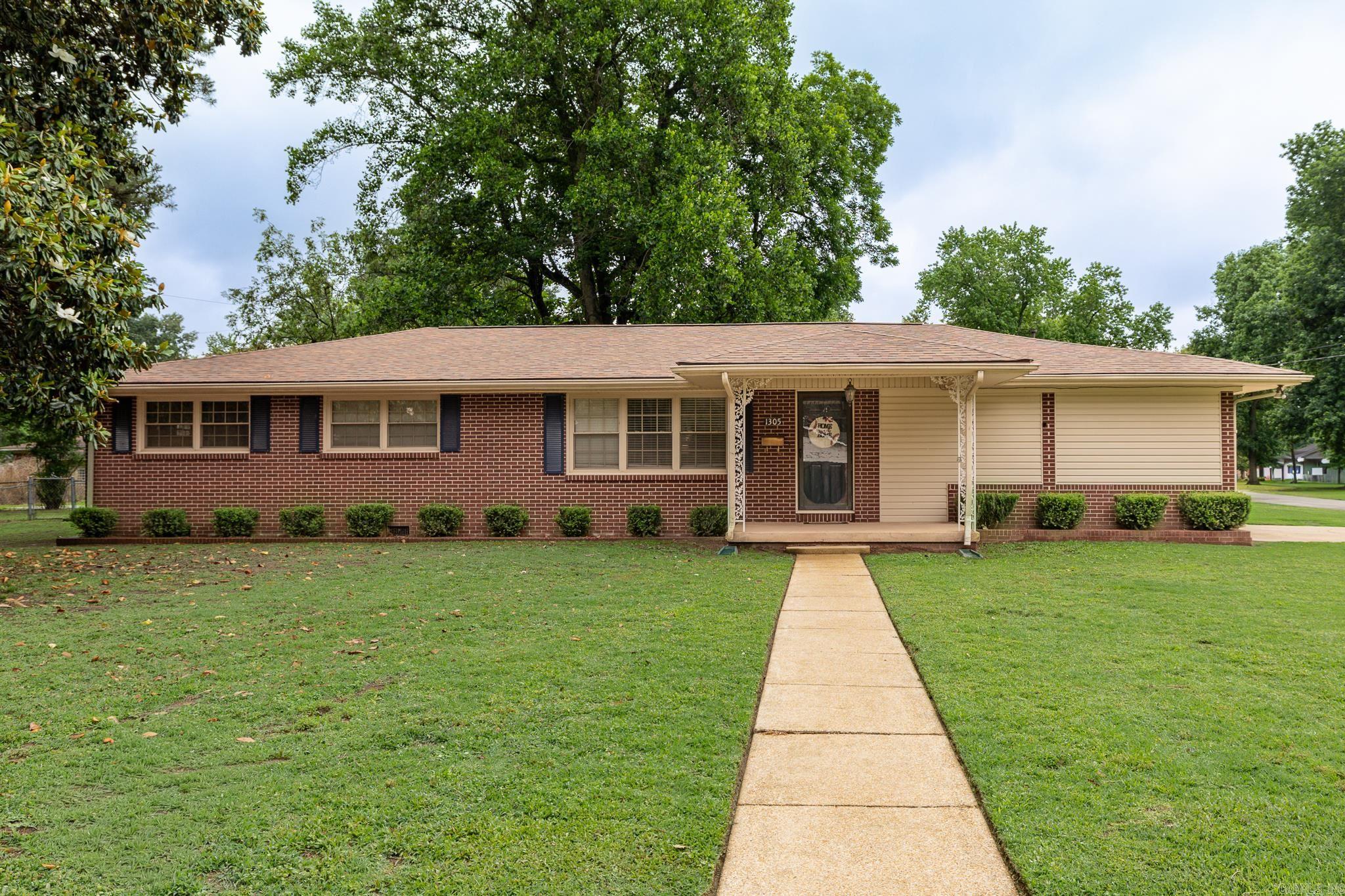 This lovely 4-bedroom, 2-bathroom brick home offers 1,708 square feet of comfortable living space on a spacious half-acre lot.