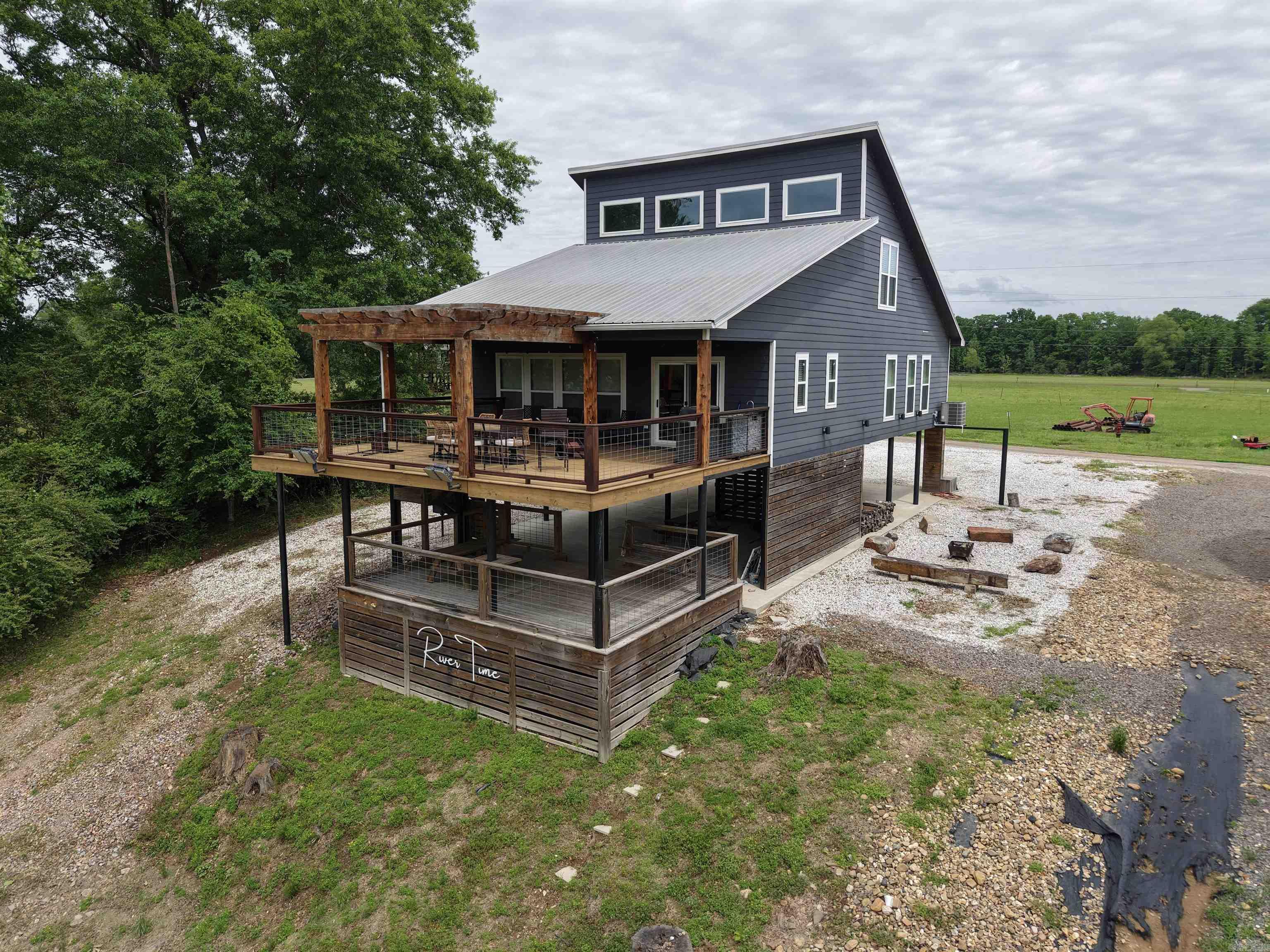 Rivertime is more than a cabin on the Caddo River — it’s a destination built for making memories. Whether you’re searching for a proven short-term rental investment, a weekend retreat, or a full-time riverside escape, this property delivers the perfect blend of recreation and relaxation. Enjoy direct access to the river for floating, fishing, and soaking in the natural beauty of the area, all while being surrounded by inviting outdoor spaces designed for entertaining, including multiple decks, a firepit gathering area, and a spacious yard.  Inside, the cabin offers an open and inviting layout filled with character, featuring a loft, bunk room, and thoughtfully crafted custom touches that set it apart from the ordinary. From cozy evenings after a day on the river to hosting guests outdoors, Rivertime captures the kind of lifestyle people come to the Caddo River to experience. Unique, memorable, and income-producing potential all in one — this is a property you’ll want to see for yourself.