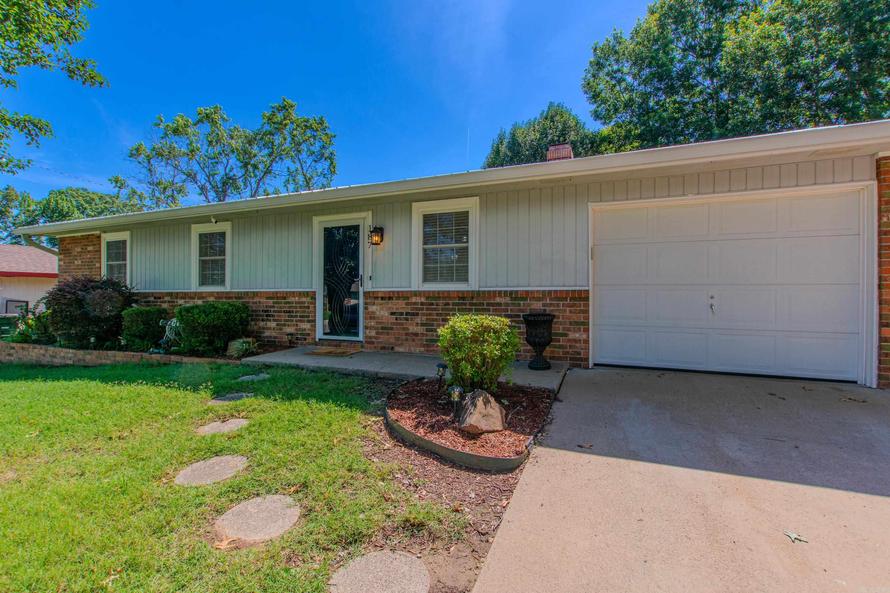 This charming 3BR/1.5BA home is full of character and curb appeal! Features include laminate flooring throughout, updated bathrooms, a cozy fireplace, and a 1-car garage. Enjoy relaxing mornings or peaceful evenings on the screened-in patio overlooking the backyard. The outdoor space also includes a shed on a permanent foundation for extra storage or workspace. Topped with a durable metal roof, this home combines comfort, style, and functionality all in one!