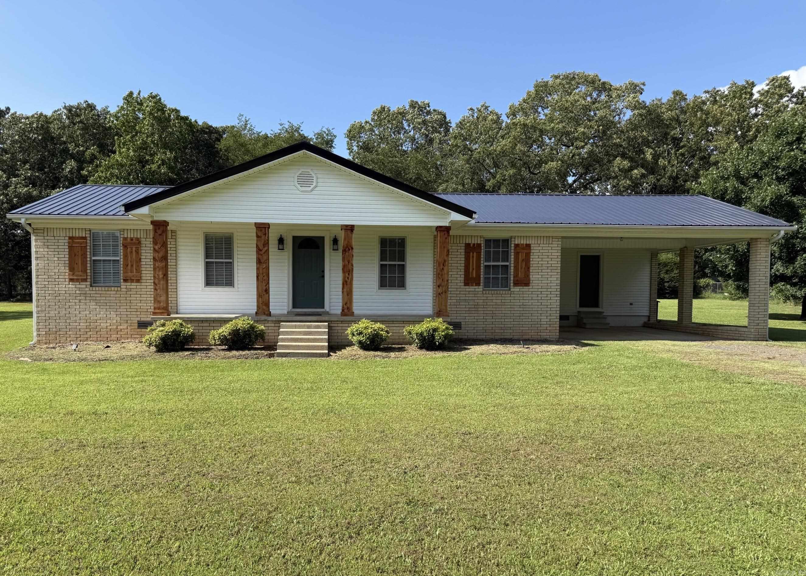 Welcome to this beautiful 3-bedroom, 2-bath home offering 1,366 square feet of comfortable living space on a large 2 acre lot in Bee Branch, Arkansas. Move-in ready and packed with recent improvements, this home features new exterior and interior doors, fresh interior paint, updated ceilings, modern light fixtures, new mini blinds, and a striking new black metal roof. Natural gas service powers the stove, heating system, and a brand-new tankless water heater, providing efficiency and convenience. The home is currently served by a private well and also has access to a city water connection. Step outside to enjoy the spacious 10' x 20' back deck overlooking a large backyard shaded by beautiful mature hardwood trees. Additional features include a 2 car carport with a storage room,  gutters and a crawl space with insulated floors and a moisture barrier for added protection and energy efficiency.  The property also comes fully fenced outside the city limits with no restrictions making it ideal for those seeking a peaceful country lifestyle.