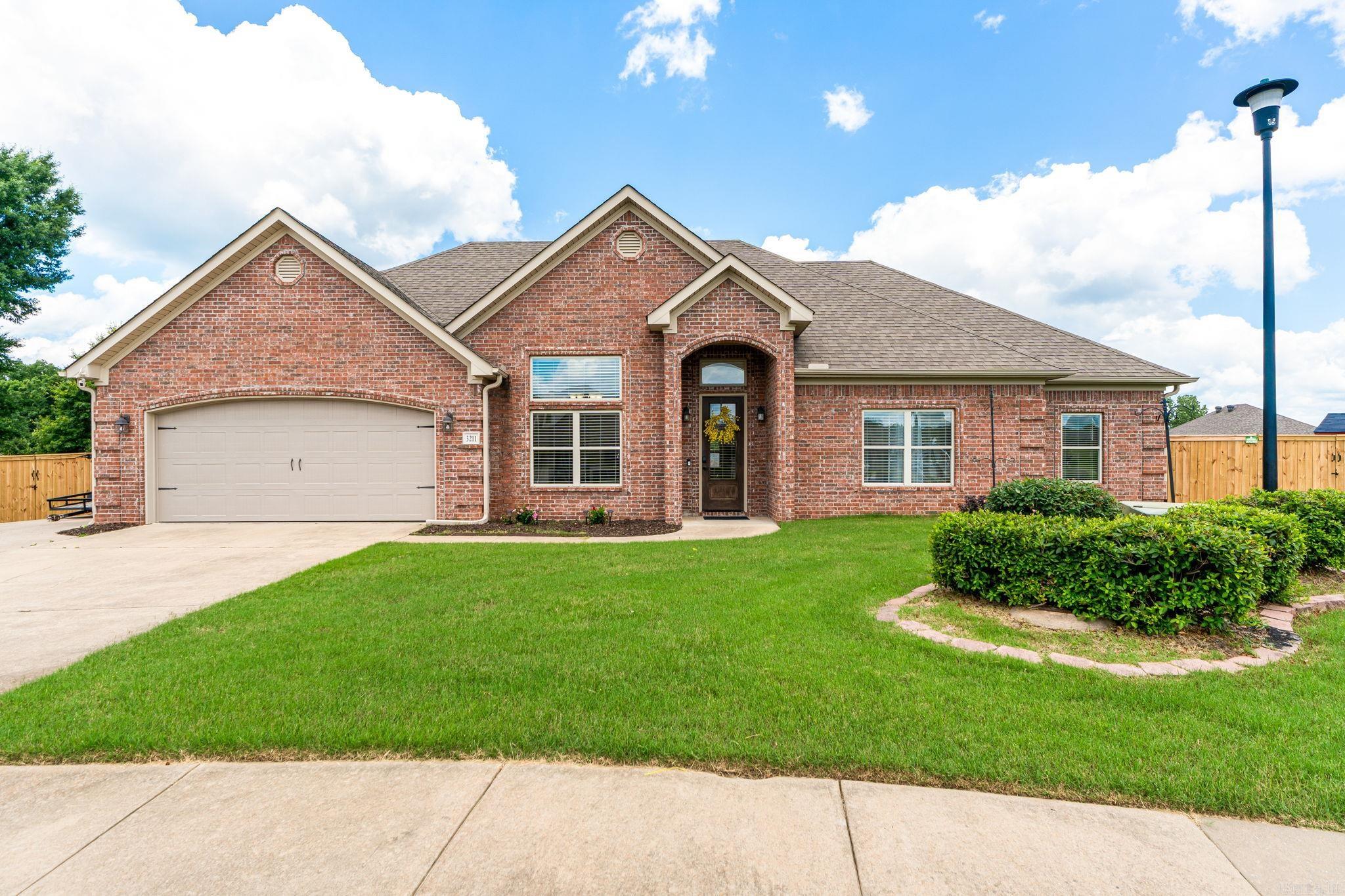 Welcome to 3211 Robbins Drive in Bryant’s desirable Andres Place Subdivision. This well-maintained 4-bedroom, 2-bath home offers 2,026 square feet of comfortable living space featuring hardwood, tile, and laminate plank flooring throughout. Inside, you'll find tall ceilings, decorative archways, a wood-burning fireplace, and quality wood cabinetry that add warmth and character to the home. A separate dining room provides a versatile space whether you are needing a second living area, formal dining space, or home office. The primary suite is private and features a large bedroom, tiled shower, and soaker tub. Situated on an oversized lot, the property includes a spacious backyard patio that’s ideal for relaxing or entertaining. Conveniently located near Bryant Parkway and Interstate access, this home offers easy access to shopping, dining, and everyday amenities while maintaining the feel of a quiet neighborhood. Located within the highly regarded Bryant School District with outdoor recreation  nearby with Mills Park, Raymar Park, and Shobe Park just a short drive away.