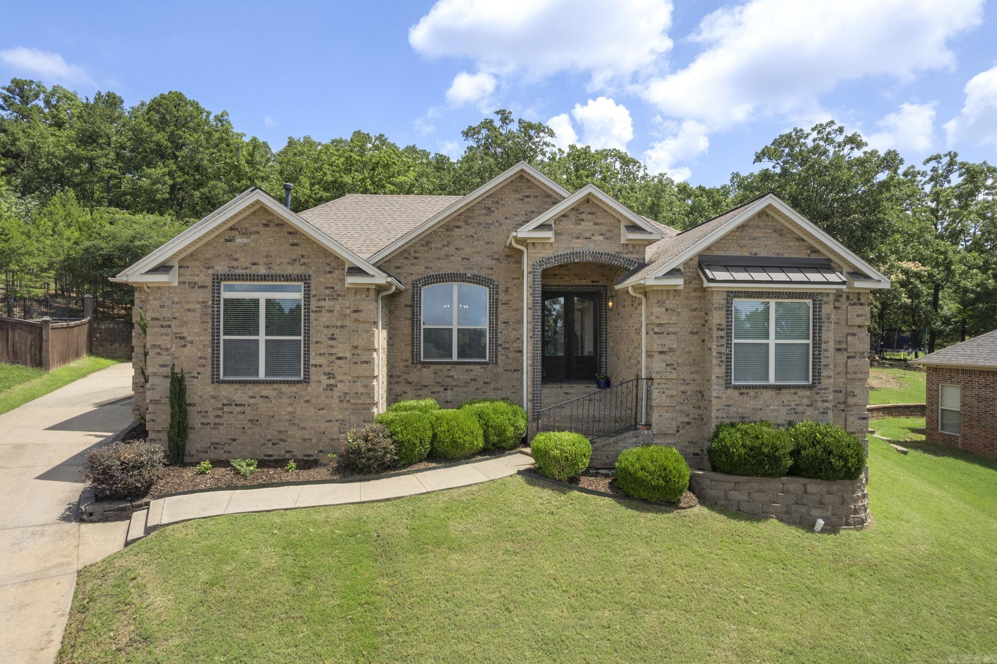In one of Maumelle's most desirable settings, this stunning home offers the perfect blend of openness, comfort, and privacy. The home features tall ceilings throughout, vaulted ceiling in primary, two fireplaces (living room and primary bedroom), and spacious open concept floor plan. Great views of the valley from the front of the home and enjoy the privacy of the backyard under the spacious covered back patio. Don't miss this beautiful home!
