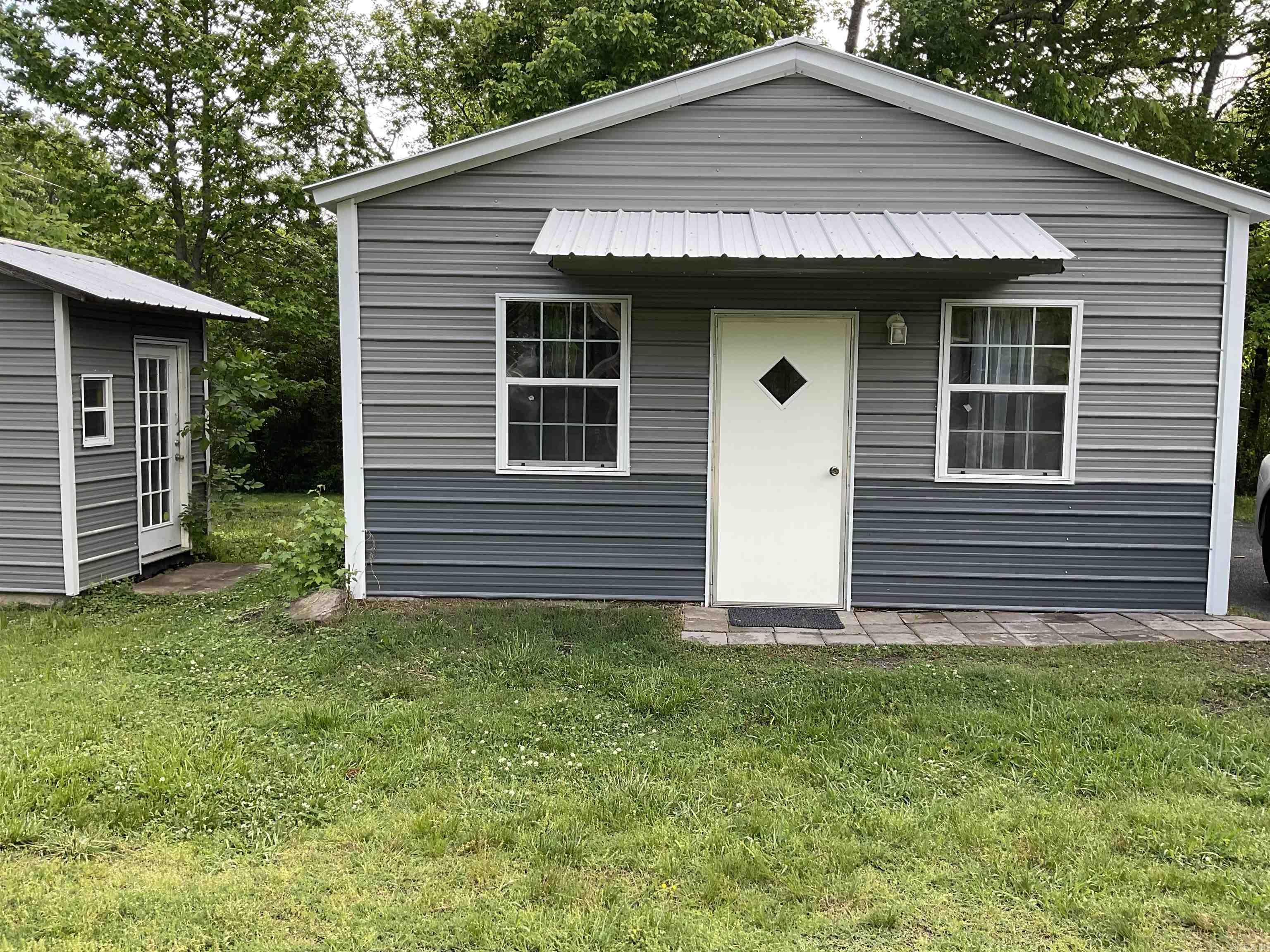 MOTIVATED SELLER !!!! Corner Lot Super cute  home with a metal storage building , Living room and kitchen have a door that separates the rooms .NEW APPLIANCES . Gas stove and dishwasher . Washer and Dryer included new 2025. All Low E windows . Perfect for someone starting out or someone could do a VRBO or Air BnB .