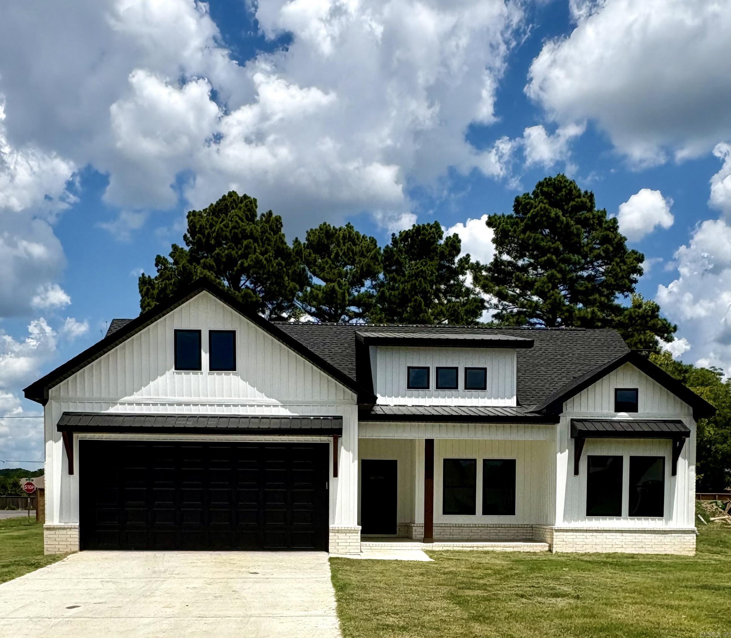 Welcome to this move in ready new construction home in  the new East Meadow subdivision in Greenbrier. Built by New Land Construction, this stunning home combines elegance with functionality, making it ideal for everyday living and hosting guests. The open floor plan has a gas log fireplace and granite countertops, which creates a spacious and inviting living space. High ceilings throughout and abundant natural light enhance the home's airy feel. Covered large porches on front and back create the perfect place  for outdoor relaxation and   entertainment. The separate primary bedroom connects with a bath with double granite vanities and a custom walk in tile shower. Custom cabinets and closets for efficient storage completes this unique home. This home has been staged to help you picture the possibilities- schedule your showing today!