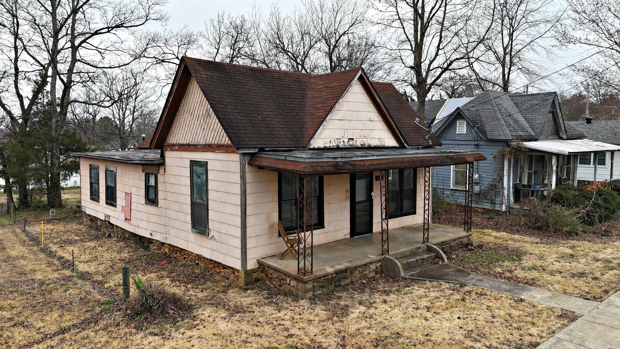 Affordable 2-bedroom, 1-bath home in Mena city limits with approximately 950 square feet of living area. The property has had some prior remodeling and updates to the kitchen and bathroom, and kitchen appliances are included in the sale. Original wood floors remain in portions of the home, and a separate dining room provides additional living space. The home would benefit from further repairs and improvements and may be suitable as an owner-occupied residence, rental, or renovation project. Conveniently located near downtown Mena with access to shopping, schools, and parks. Buyers should verify all measurements, updates, and condition to ensure the property meets their needs.