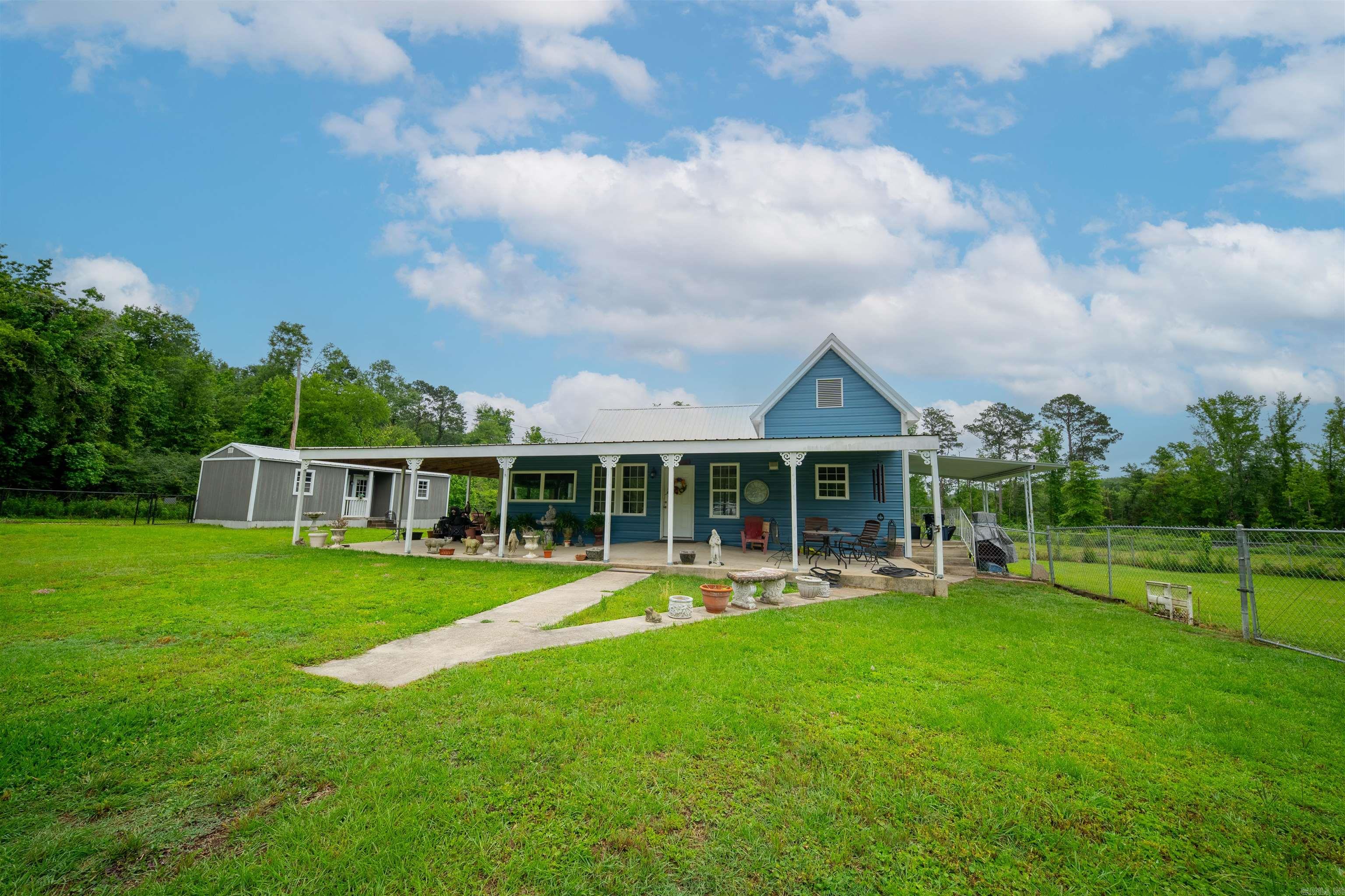 Nestled on 7 acres of serene countryside, this unique property offers two charming homes and a fully stocked pond, creating the perfect retreat for family, friends, or multi-generational living. The first home features 2 bedrooms and 1.5 bathrooms, offering a cozy, comfortable space with thoughtful living areas. The second home boasts 3 bedrooms and 2 bathrooms.. Outside, the expansive acreage invites outdoor enjoyment, while the stocked pond adds a picturesque touch and opportunities for fishing and leisurely afternoons by the water. This property combines privacy, versatility, and natural beauty, making it a rare find for those seeking a peaceful, country lifestyle.