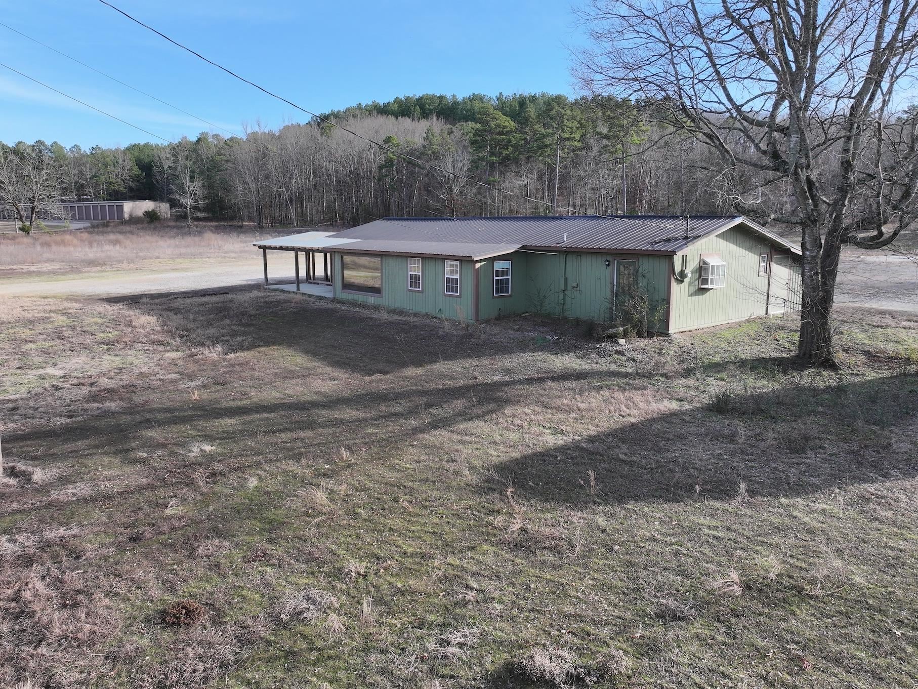 Prime Investment Opportunity Near Lake Ouachita! Looking for a property with tons of potential? Check out this 1,500 sq. ft. building located on 4.7+/- acres just minutes from beautiful Lake Ouachita! Formerly known as Road Trip’n, this property has been partially developed with 3 septic tanks, city water, and an RV dump station, making it perfect for a variety of uses. While the building currently has a bathroom and kitchen, there is no shower or tub, allowing you to customize it to fit your needs. Whether you're thinking about a rental, retreat, or other ventures, this location offers plenty of space and possibilities. Located at 2383 Hwy 270 E, Mount Ida, Arkansas, don’t miss out on this opportunity to own a piece of land with HWY 270 frontage!