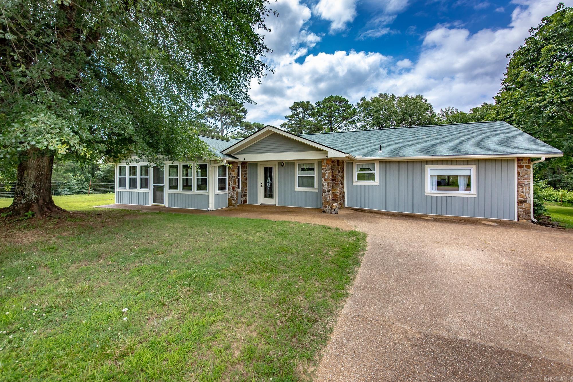 Don't miss this peaceful retreat situated on 1.5+ tranquil acres, just approximately 0.5 miles from beautiful Greers Ferry Lake. This well-maintained home features 2 bedrooms, 2 bathrooms, and two spacious living areas, offering plenty of room to relax or entertain. Enjoy the large enclosed porch, complete with a built-in grill vent, making it an ideal space for year-round gatherings. Outside, you'll find an additional storage building for all your tools, lake gear, or hobbies. Recent updates include new vinyl flooring, a new roof installed in 2022, and newer siding completed in 2021, providing added value and peace of mind.  Conveniently located just 1.5 miles from Fairfield Bay Marina, this property offers easy access to boating, fishing, and all the recreational opportunities Greers Ferry Lake has to offer. Whether you're looking for a full-time residence, weekend getaway, or investment property, this home is ready for you to enjoy.